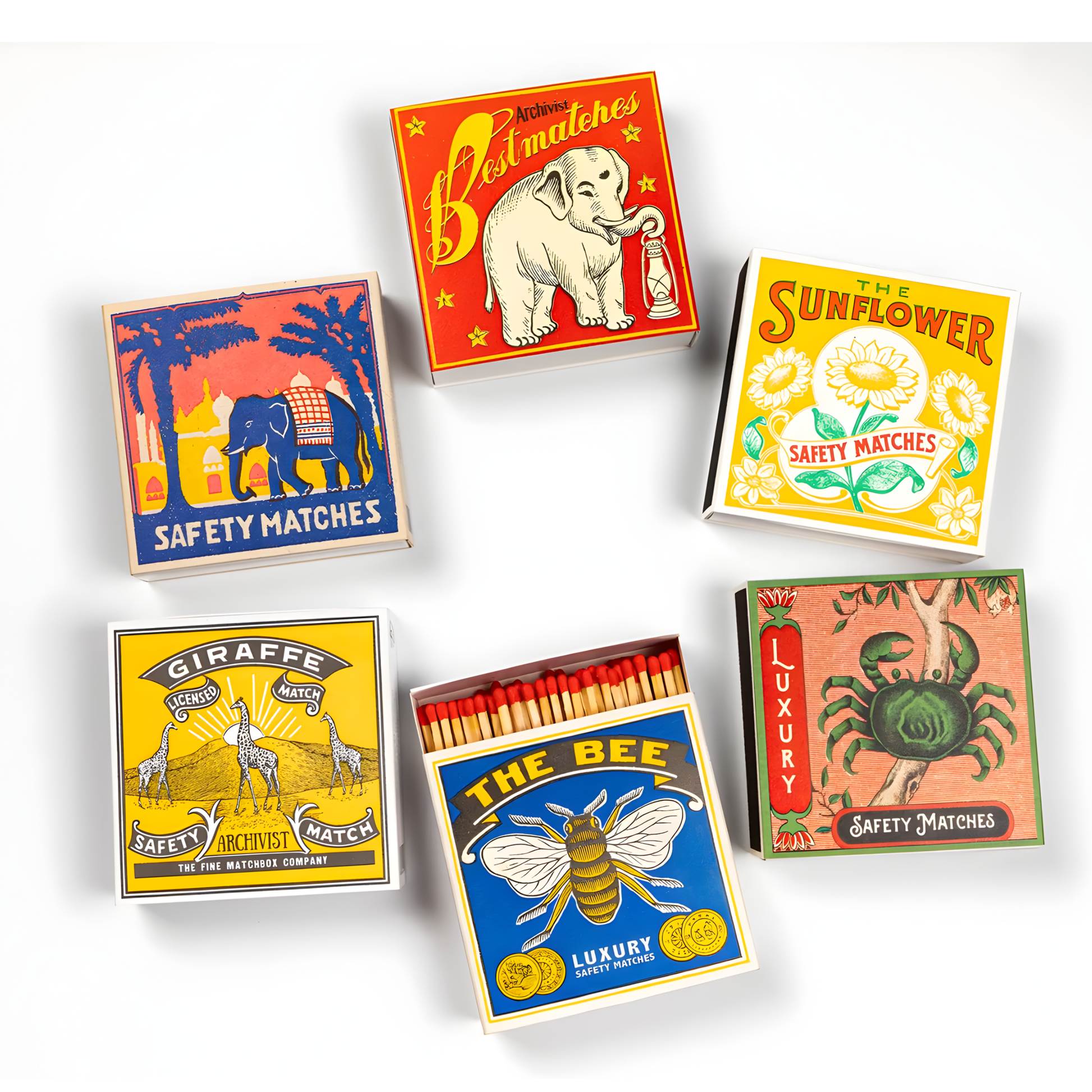 With other match boxes, the Archivist Luxury Matches The Bee which features a bumblebee on a blue background with the words "The Bee, Luxury Safety Matches." Contains 125 matches (100 mm, yellow tips, white tray), letterpress printed in the UK with FSC-certified wood and wrapped in compostable cello-perfect for coffee tables, mantelpieces, or gifting.