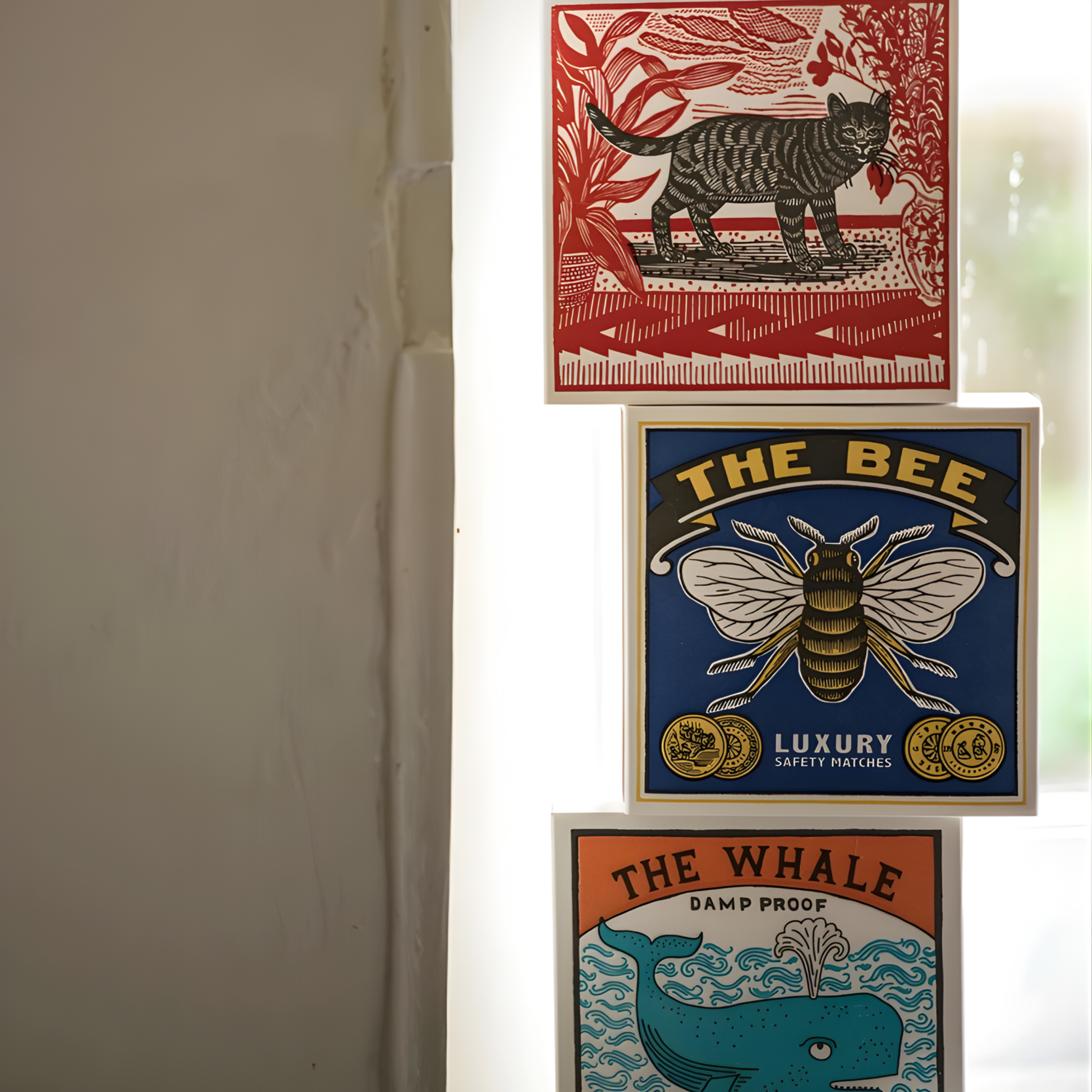 Stacked between the cat and the whale matchboxes, the Archivist Luxury Matches The Bee which features a bumblebee on a blue background with the words "The Bee, Luxury Safety Matches." Contains 125 matches (100 mm, yellow tips, white tray), letterpress printed in the UK with FSC-certified wood and wrapped in compostable cello-perfect for coffee tables, mantelpieces, or gifting.
