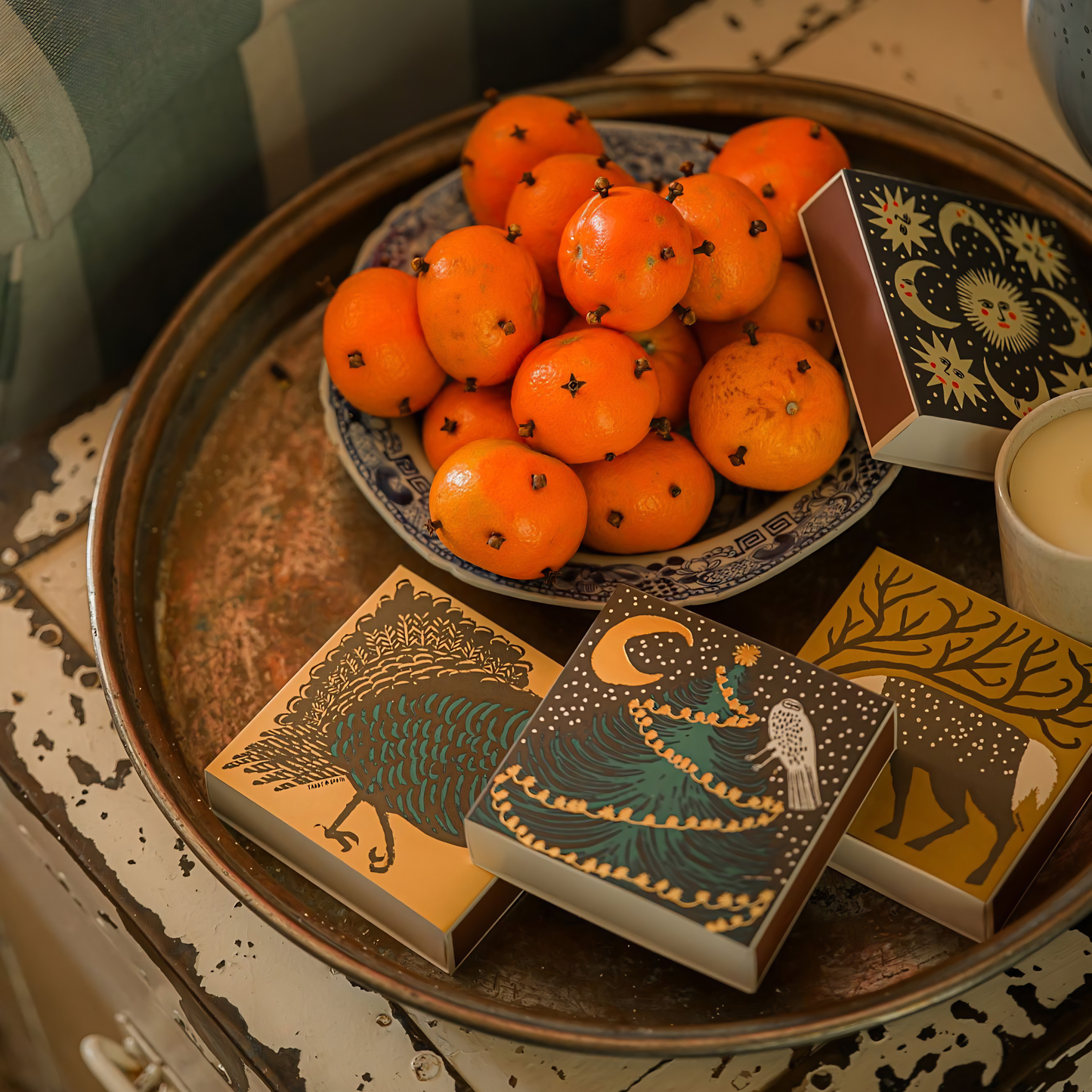 Seen on a tray with other matchstick designs, the Archivist Luxury Matches featuring the illustration of a black turkey.