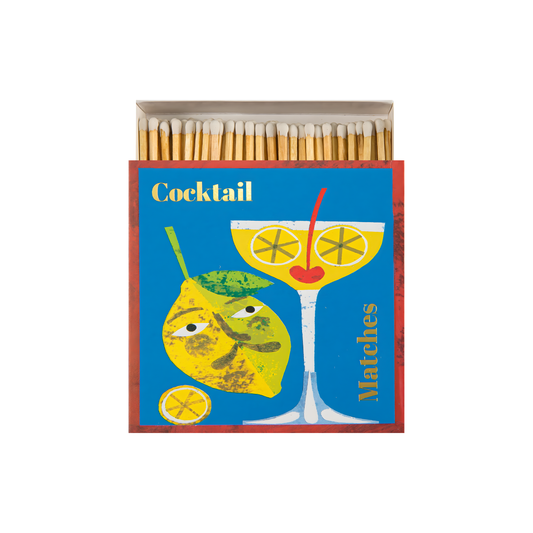 Front view and open Archivist Luxury Matches Cocktail which features a playful cocktail glass with a lime and gold foil detail, designed by Marion Elliot. Contains 125 matches (100 mm, yellow tips, white tray), litho printed in the UK with FSC-certified wood and wrapped in compostable cello-perfect for coffee tables, mantelpieces, or gifting.