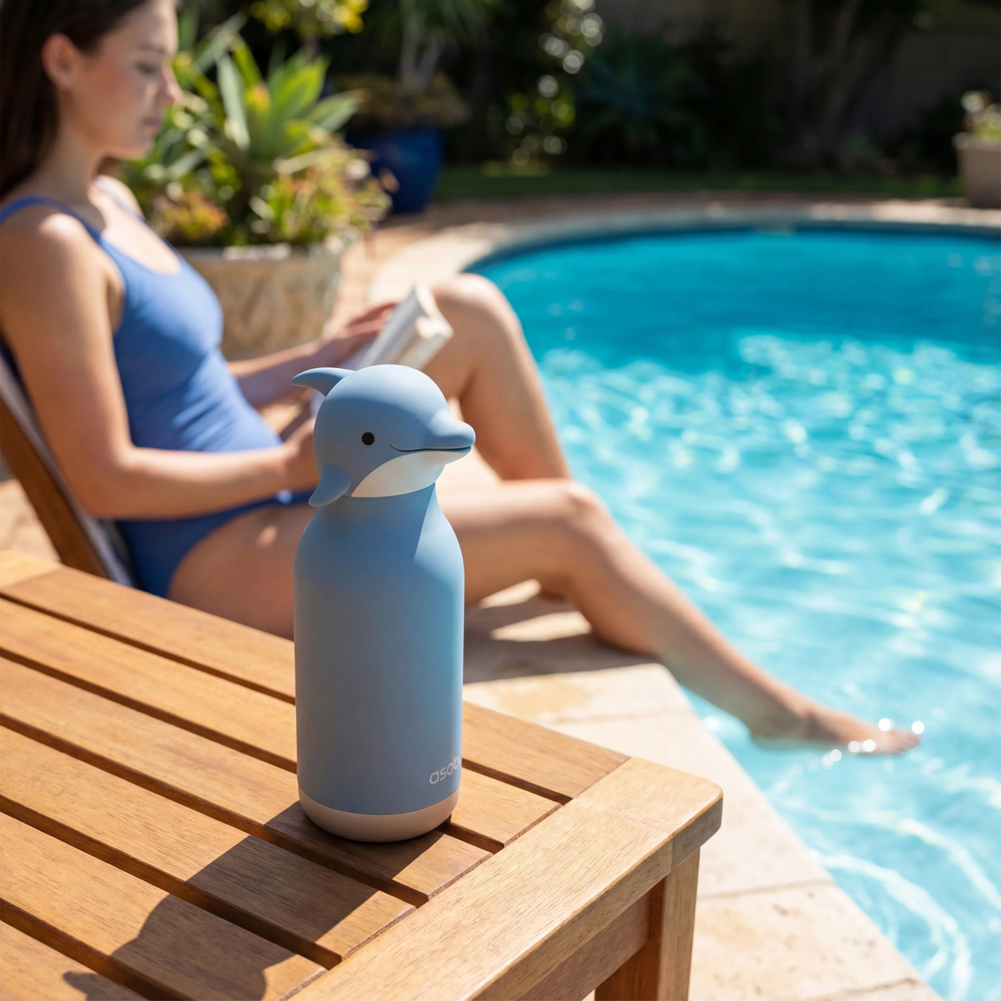 Asobu Bestie Bottle 460ml Dolphin on a table in the pool side.