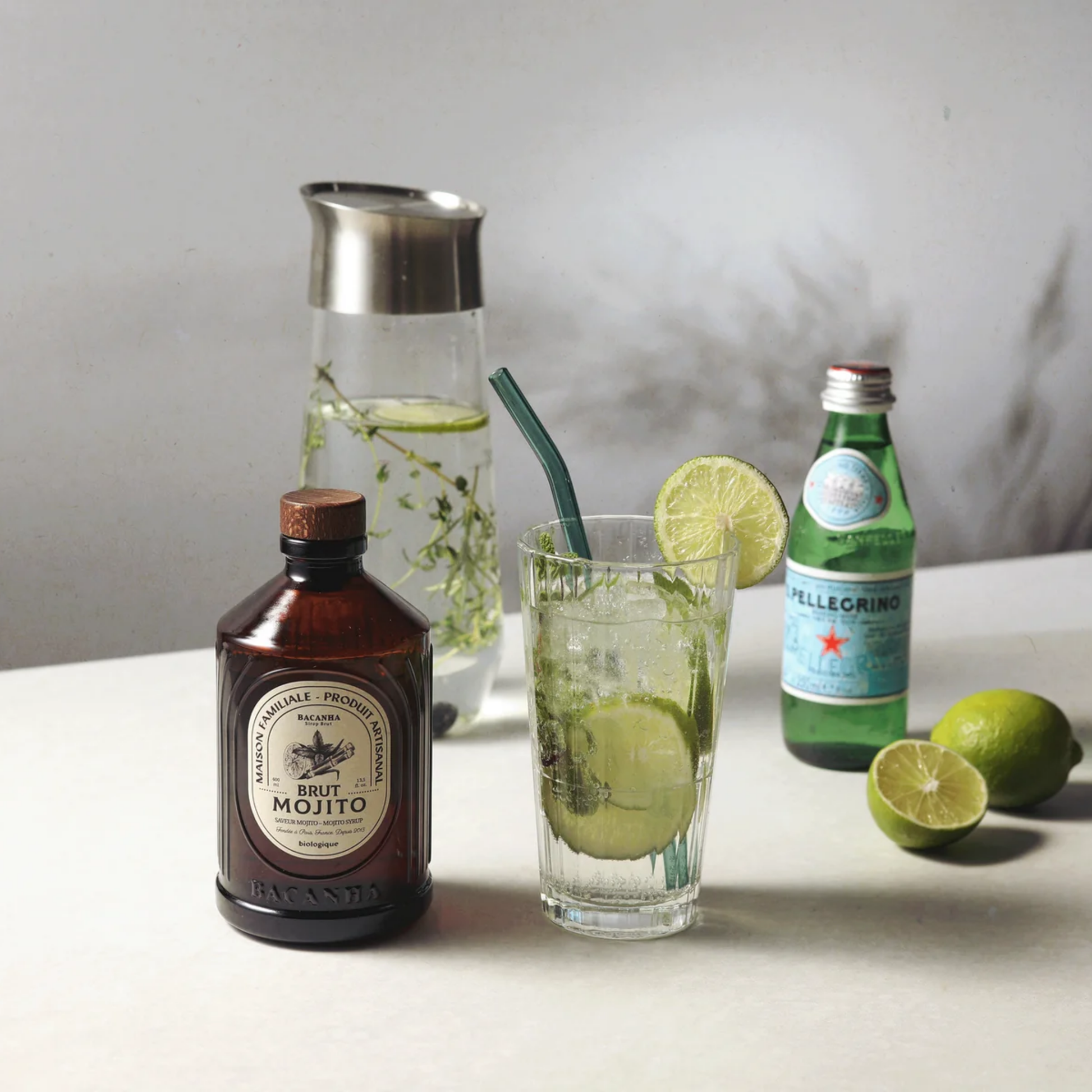 Bacahna sirop on display with other cocktail ingredients on marble table