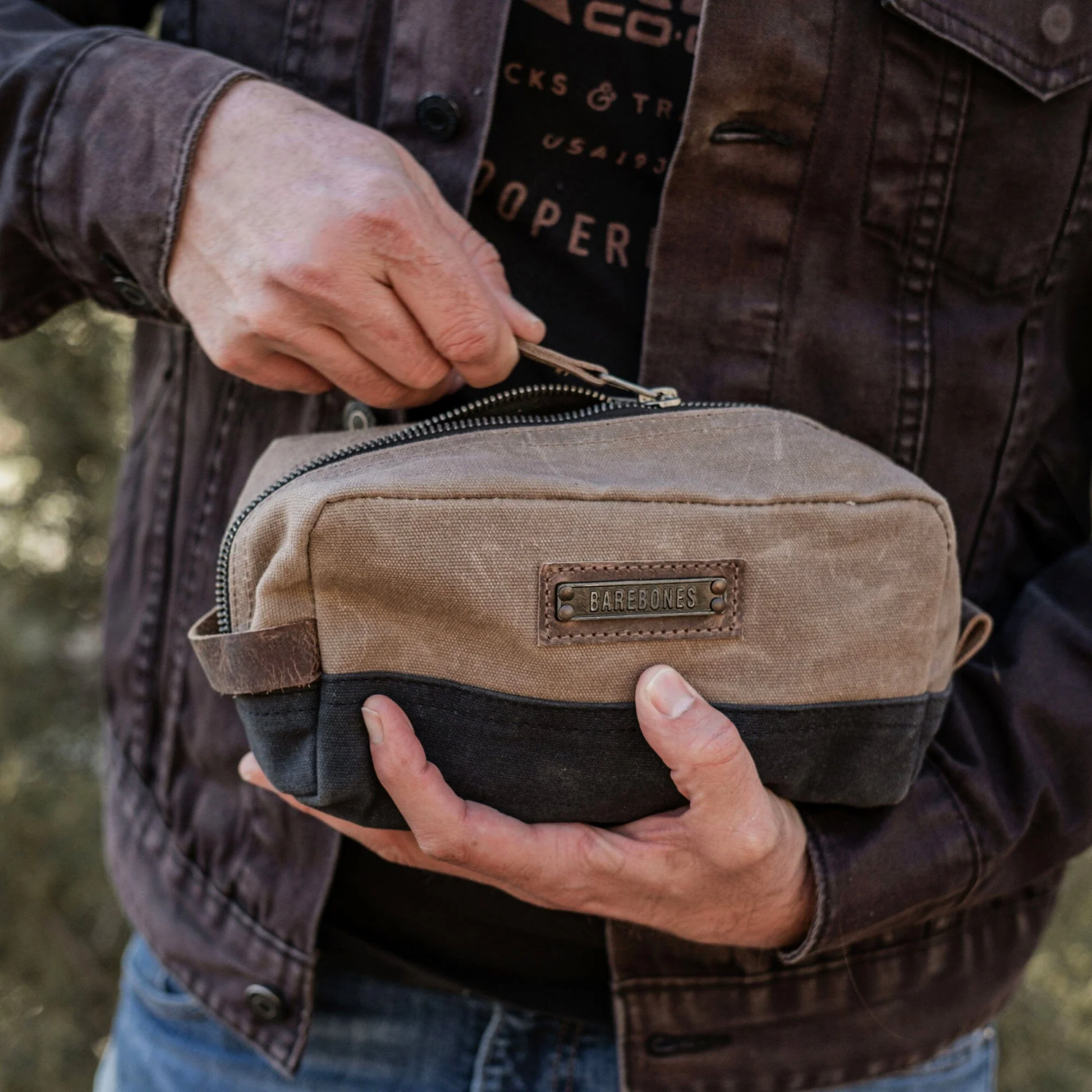 Man unzipping the Neelum drop kit outdoors