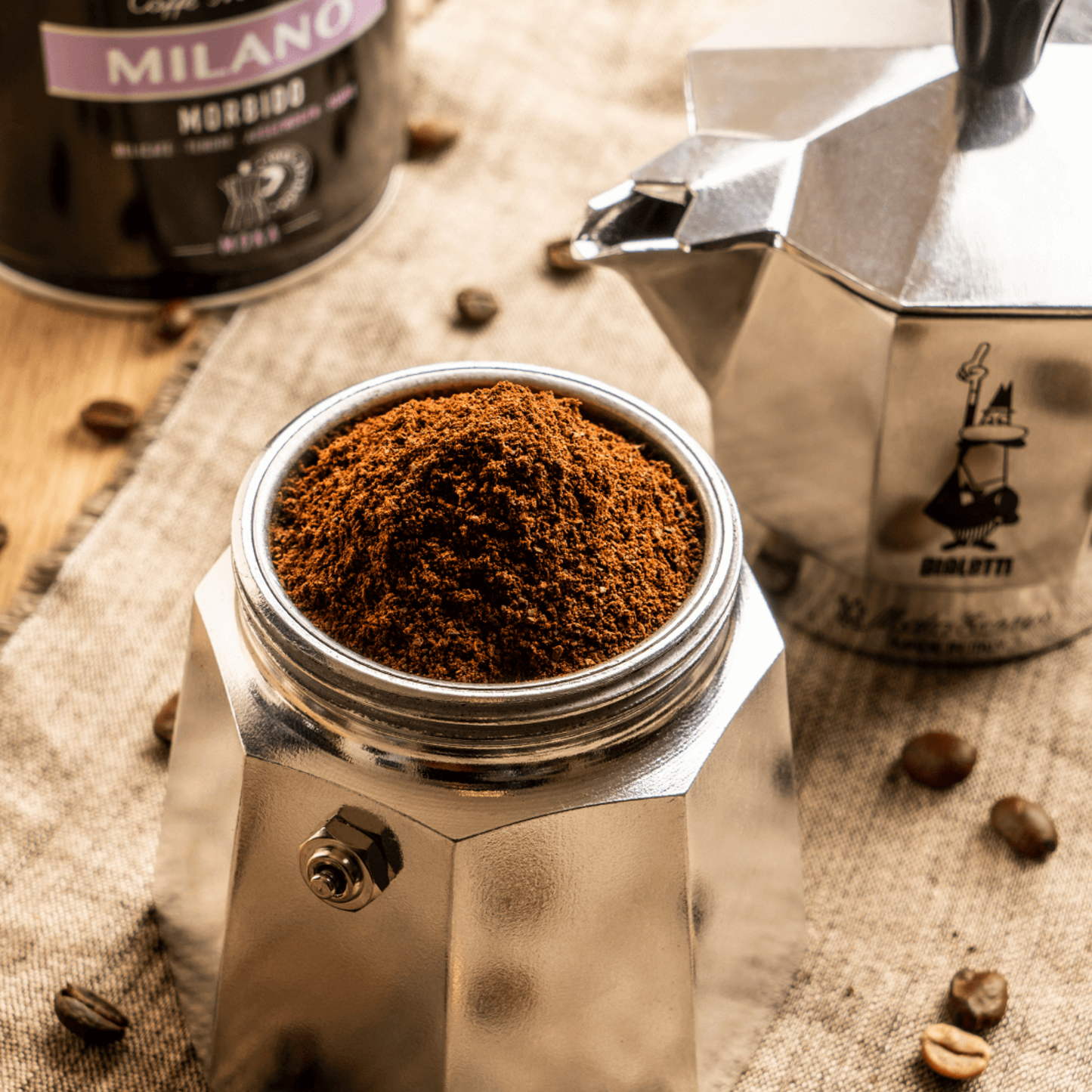 Lower chamber with coffee inside view of Bialetti Moka Express 6-cup stovetop coffee maker, medium-size aluminum brewer with black handle and knob, producing rich, full-bodied Italian espresso, ideal for everyday coffee moments.