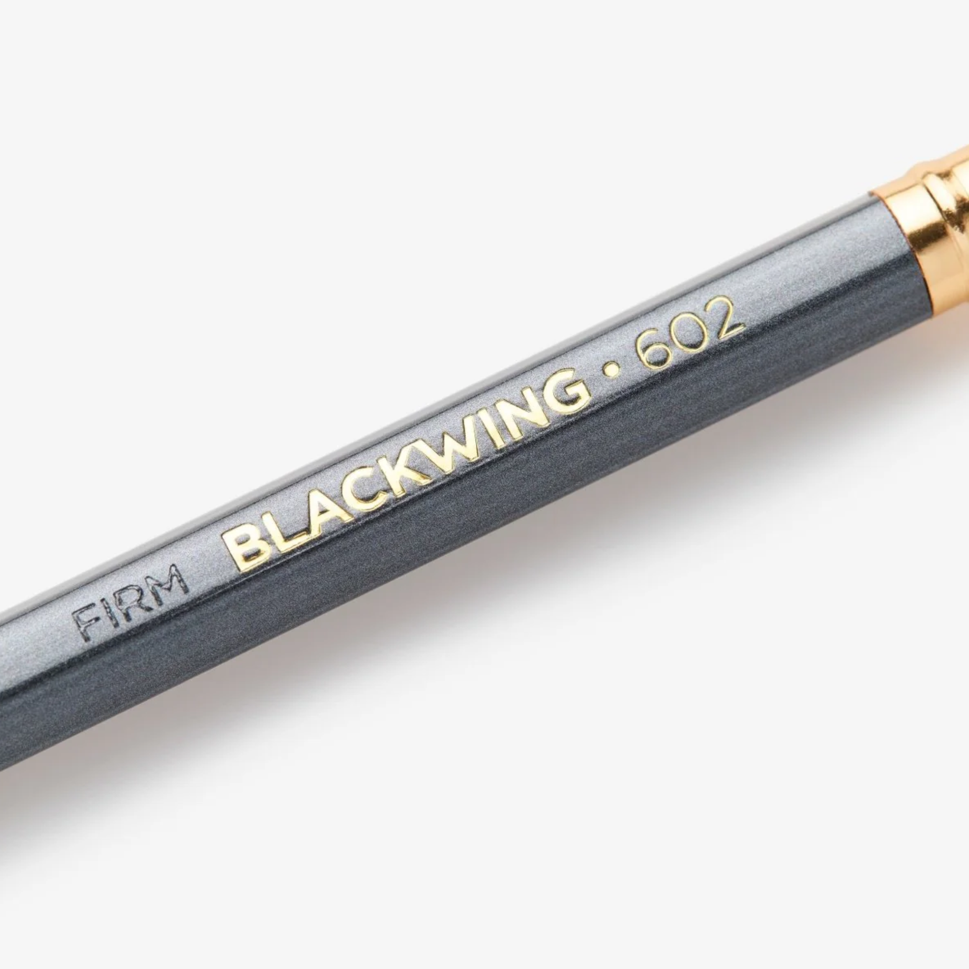 Close up view of the Blackwing 602 gunmetal grey pencil with firm graphite core and pink eraser - iconic 'Half the Pressure, Twice the Speed' design.