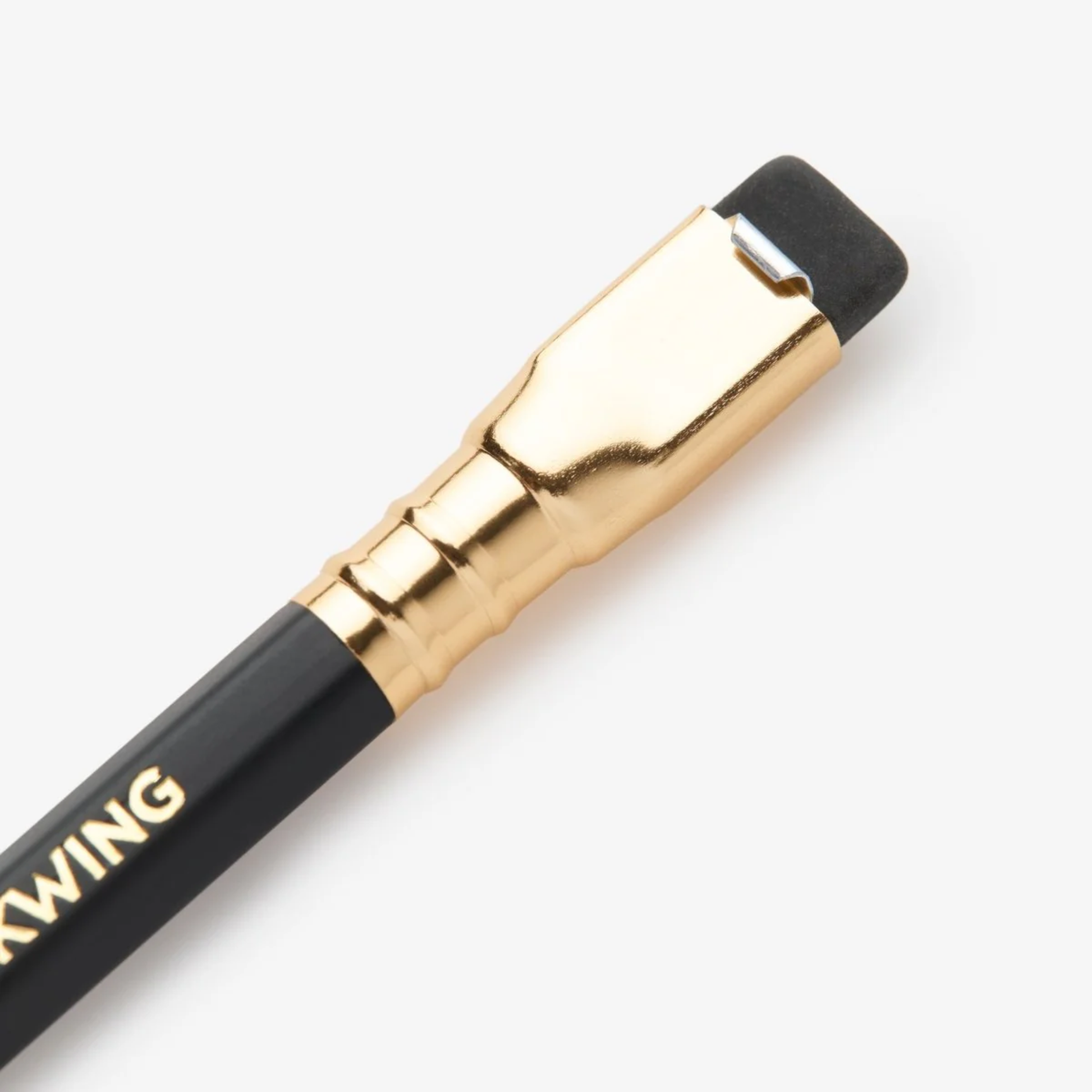 Close up view of the eraser part of the pencil from Handwriting shown using Blackwing Matte black pencil with soft graphite core and square metal ferrule.