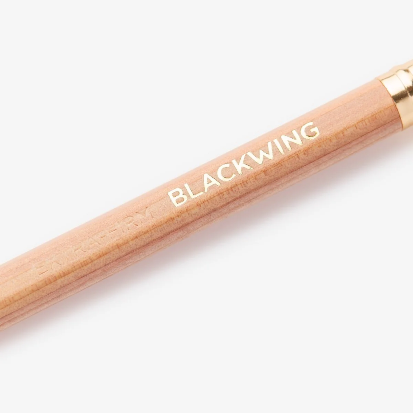 Close up of the logo from Blackwing Natural pencil, extra-firm graphite incense-cedar pencils with clear matte finish, grey eraser, and silver ferrule for precise writing and drawing.