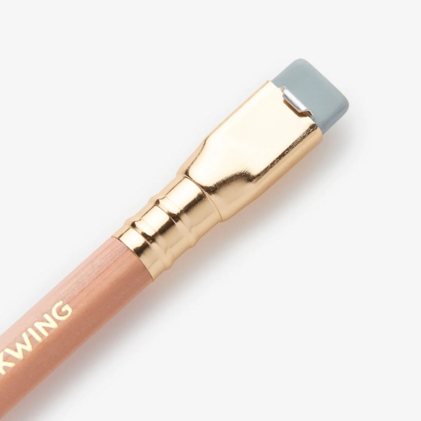 Close up view of the bottom part with the eraser from Blackwing Natural pencil, extra-firm graphite incense-cedar pencils with clear matte finish, grey eraser, and silver ferrule for precise writing and drawing.