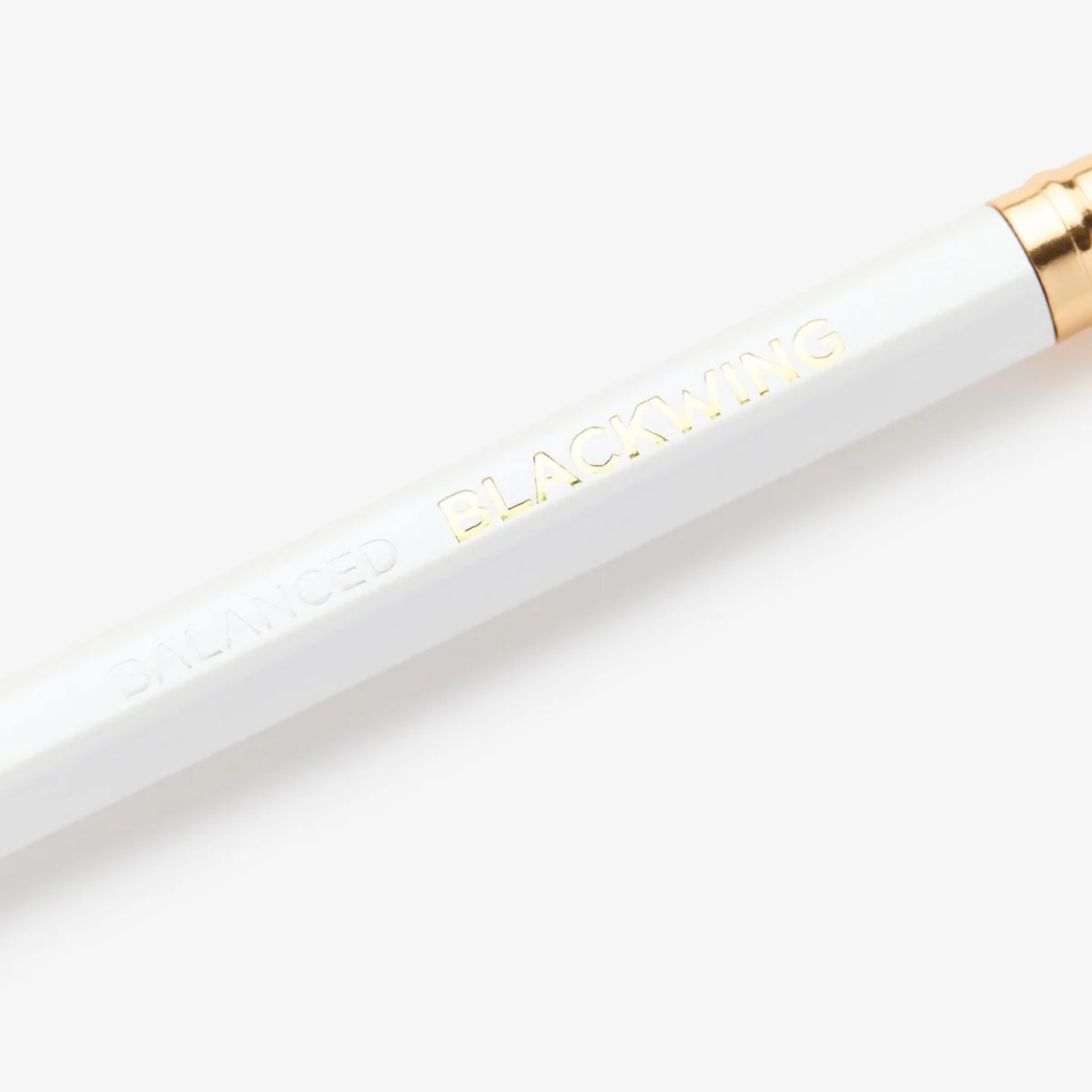 Close up view of the Blackwing logo on the pencil for Blackwing Pearl pearlescent white pencil with balanced graphite core, square metal ferrule, and replaceable eraser.