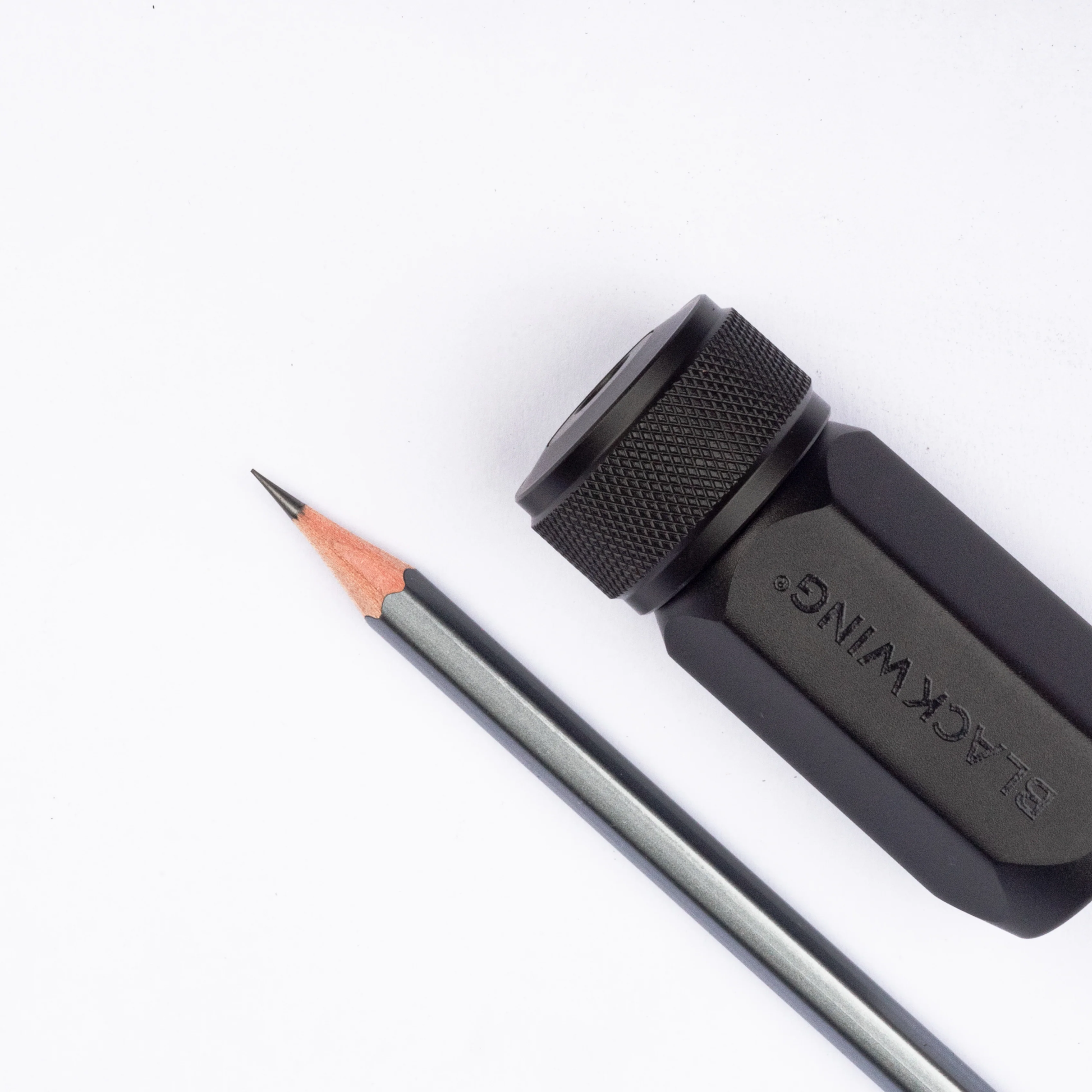 Shown with a blackwing black pencil Blackwing One-Step Long Point Sharpener in black machined aluminum with German steel blade.
