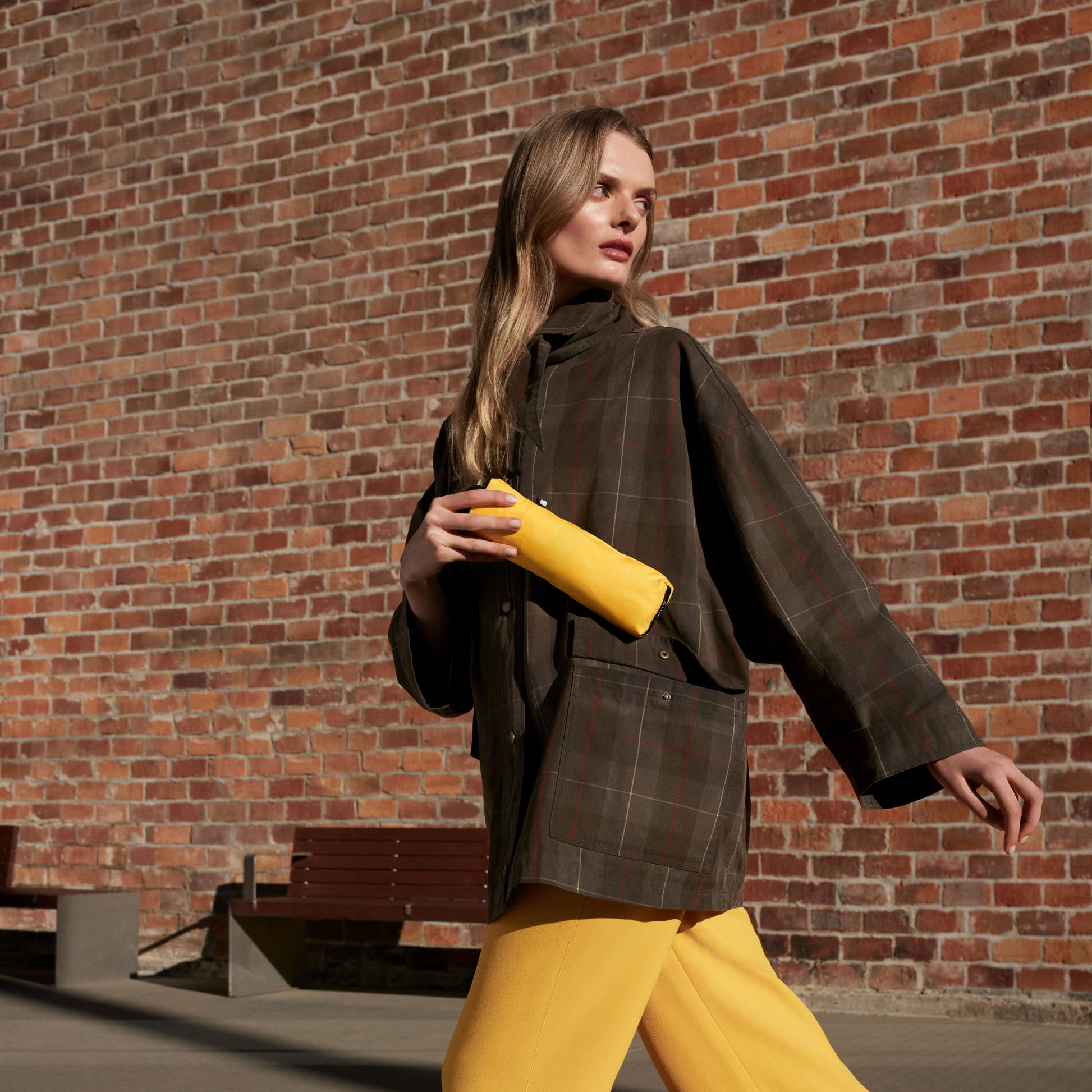 Seen from the pocket, the Blunt Umbrella Neo Citrus Yellow, featuring a compact design with high tensioned canopy, wind tested construction and recycled rPET fabric for rain or shine.