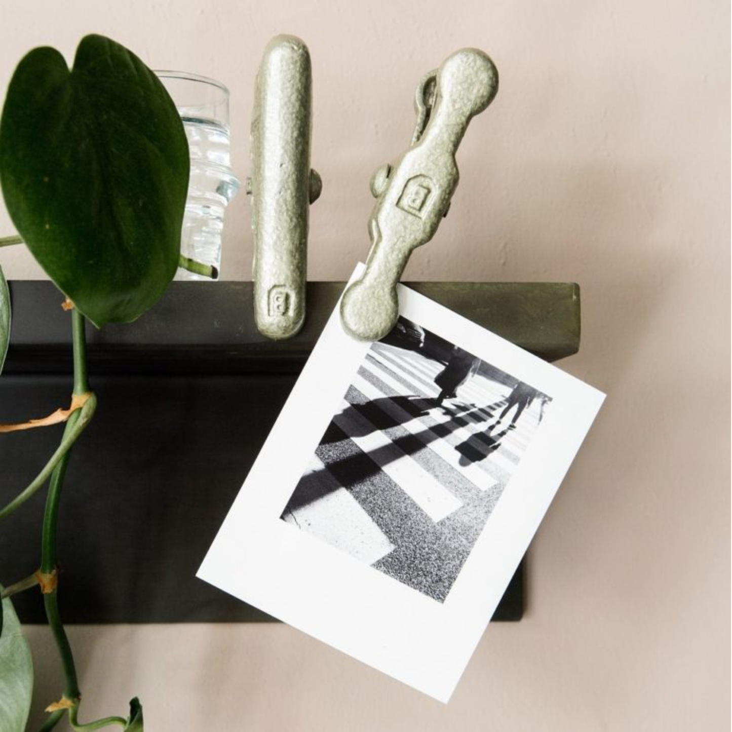 Shown clipping a picture Brut Homeware vintage-style cast aluminium clip with hammered finish, wall-mountable and handmade in India-perfect for holding photos, receipts, or notes with industrial charm.