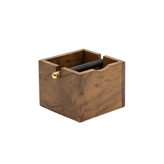A compact, square wooden Coffee Knock Box by Brut, featuring an open top and a brass accent on one side, designed for convenient coffee grounds disposal.