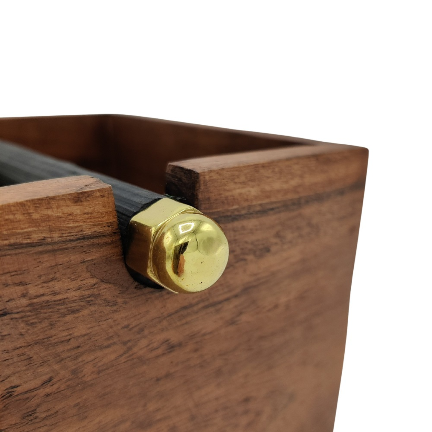 A close-up of the Brut Coffee Knock Box, highlighting a shiny brass hex nut and cap that secure a dark metal rod to the wooden box corner.