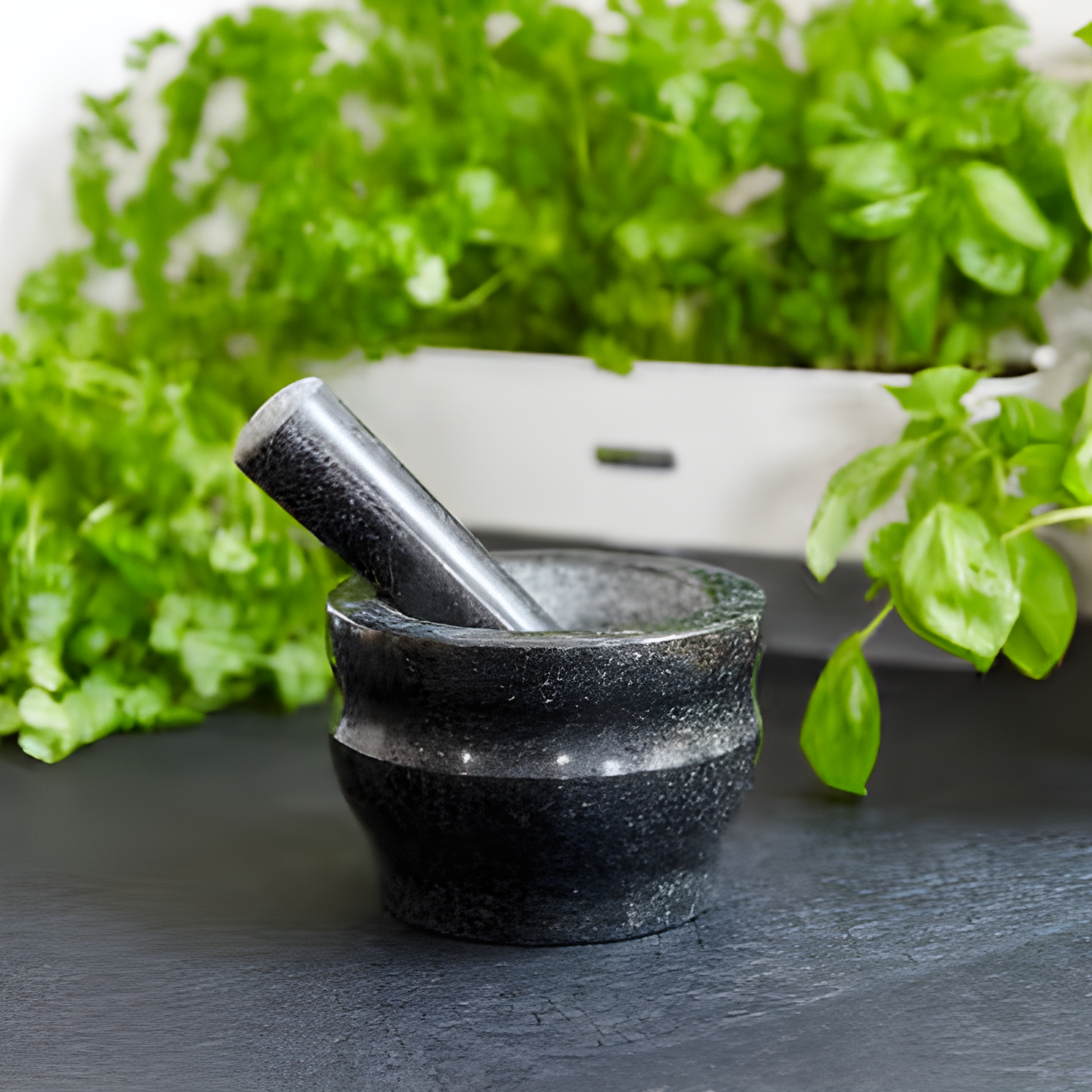 Table view Cole & Mason small black granite pestle and mortar, 14 cm bowl, with ridged base and long handle for stable grinding of wet or dry mixes.