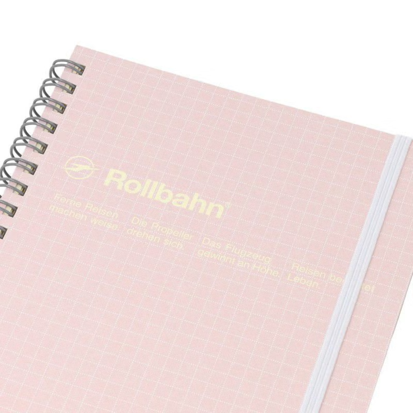 Close up view of the Fathom spiral bound retro notebook in baby pink with polypropylene cover, metal spiral binding, elastic closure, and 140 perforated cream pages, large Japanese-made stationery.