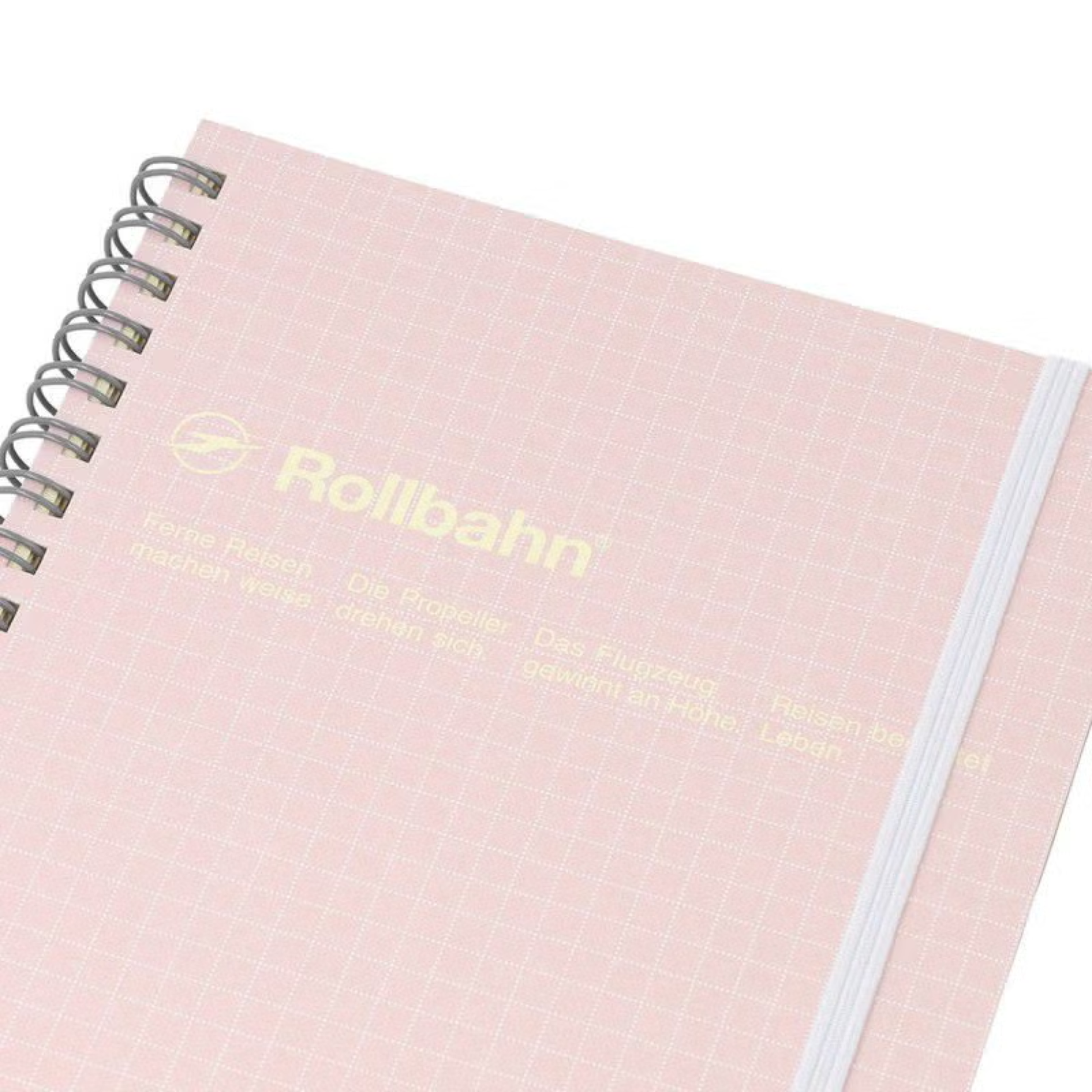 Close up view of the Fathom spiral bound retro notebook in baby pink with polypropylene cover, metal spiral binding, elastic closure, and 140 perforated cream pages, large Japanese-made stationery.