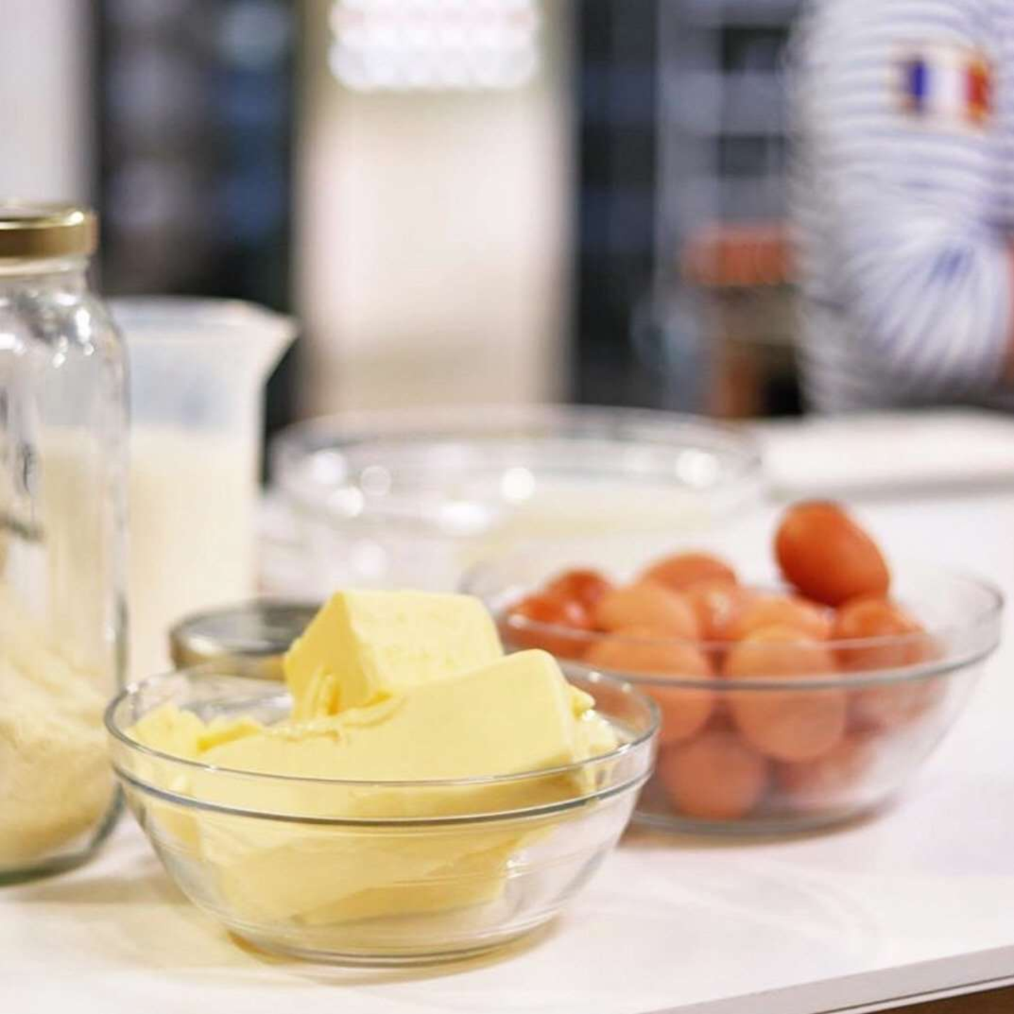 Duralex Le Gigogne stackable transparent glass salad bowl, shown with butter and eggs, 2.4 L - 23 cm, rounded shape, ideal for salad, punch, or sauce.