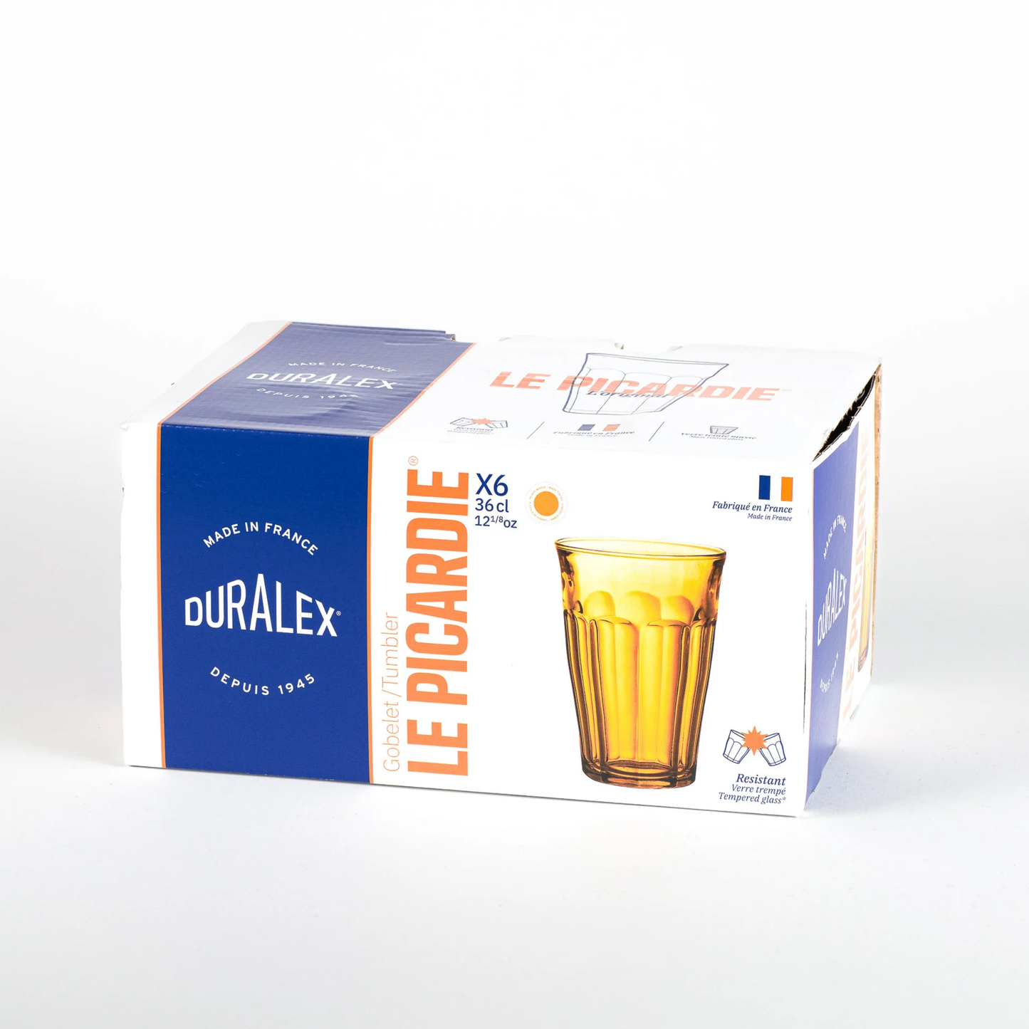Packaging of Duralex Picardie tempered glass tumbler, Amber, with a thick base and comfortable-to-hold design. The glass is durable, hygienic, and safe for both the microwave and dishwasher.