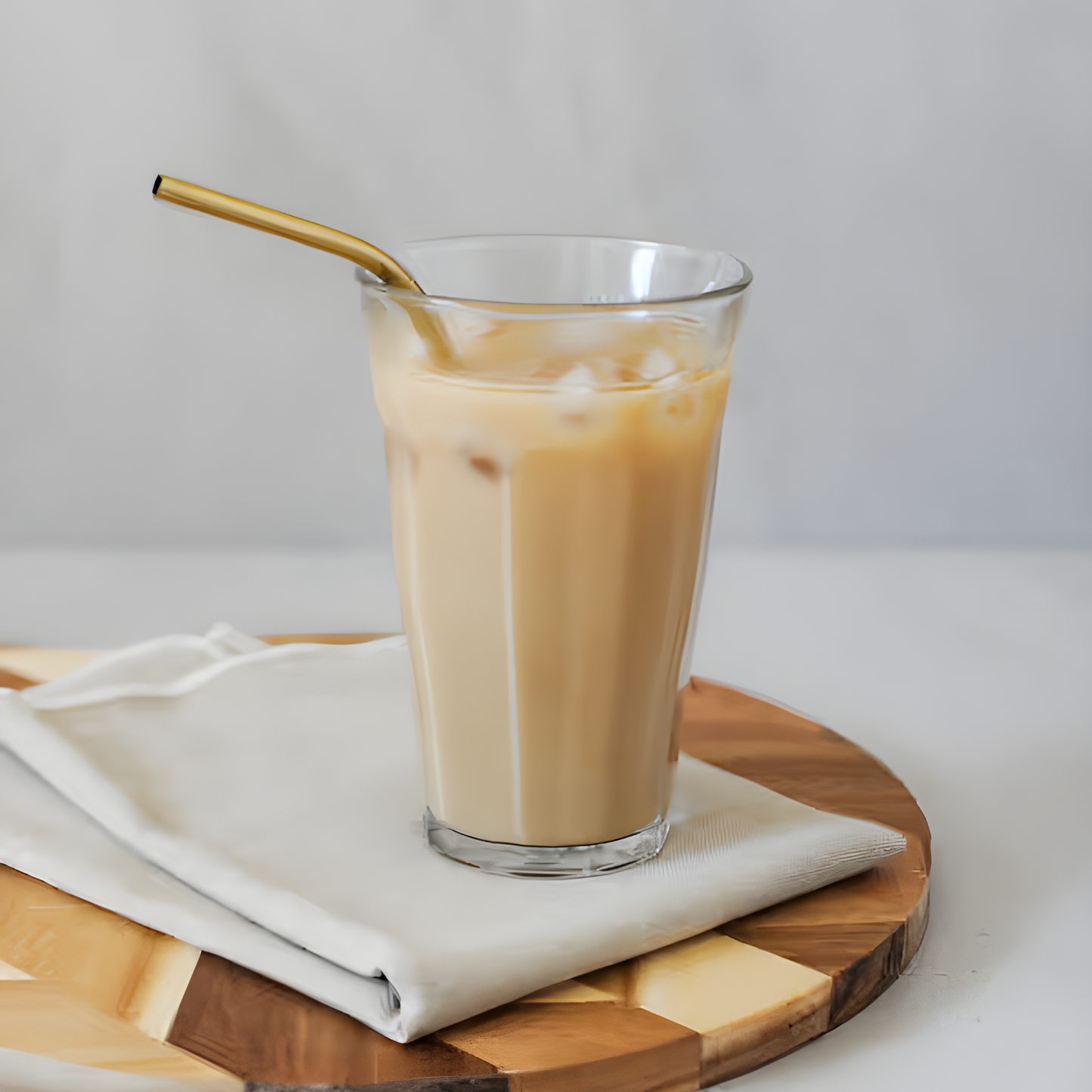 Duralex Picardie tempered glass tumbler, clear, with a thick base and comfortable-to-hold design. The glass is durable, hygienic, and safe for both the microwave and dishwasher, shown on the table with iced coffee.