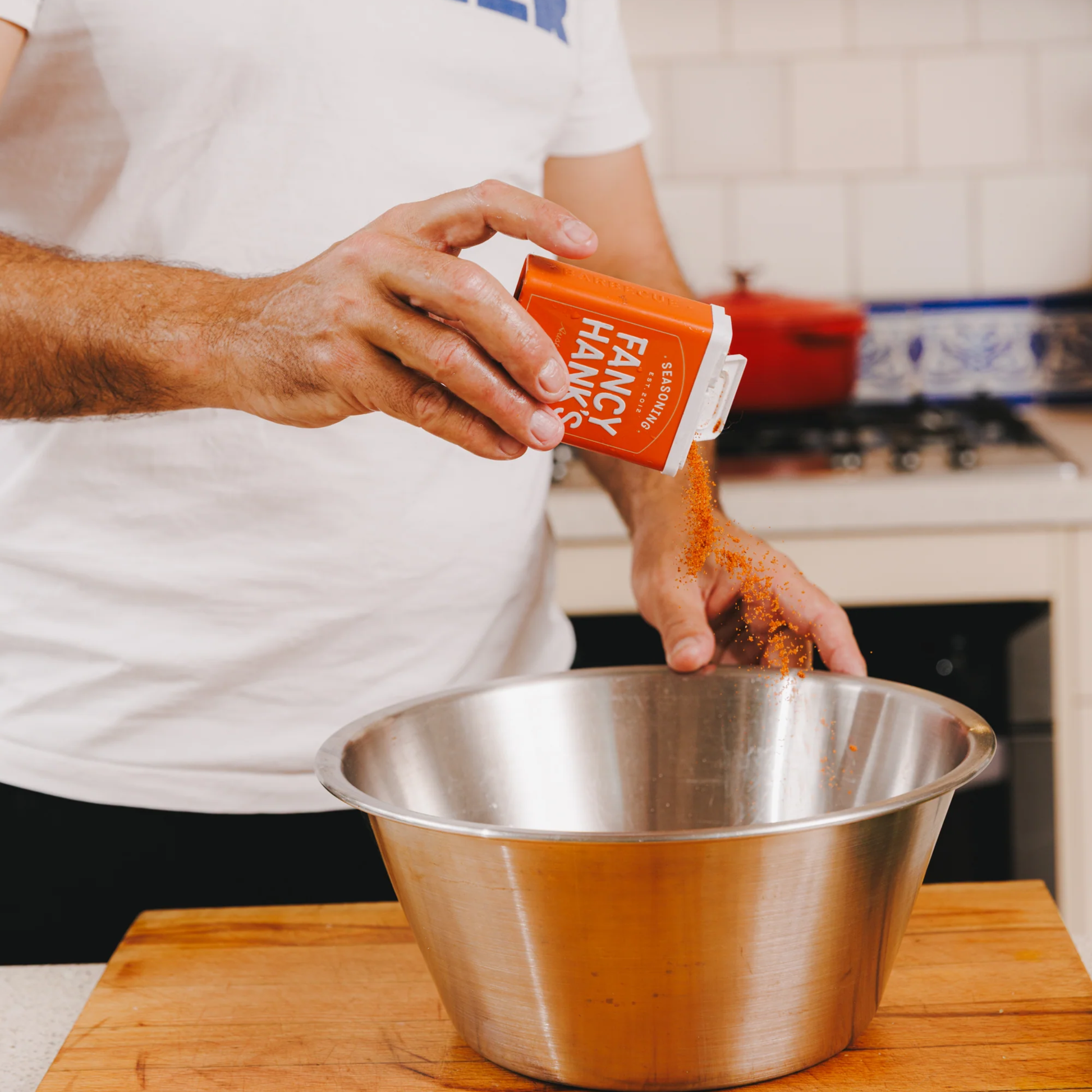 Showing a person adding the Fancy Hanks Taco Rub 90g in to a bowl, a bold vegan friendly spice blend for tacos, and anything that needs a flavour hit. No preservatives added.