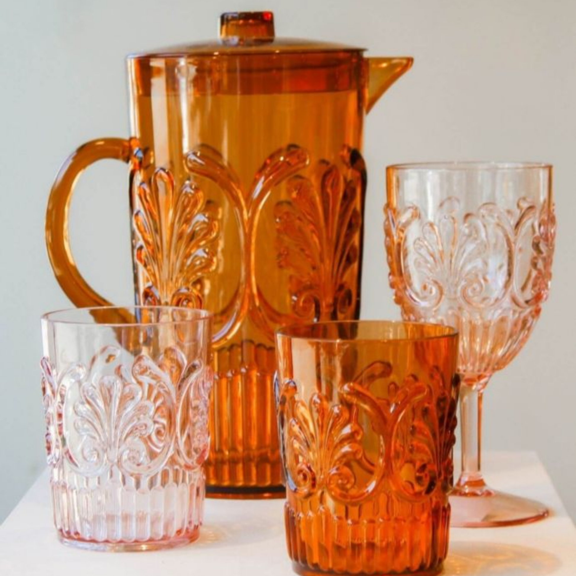 Acrylic glassware amber and pale pink on display on table