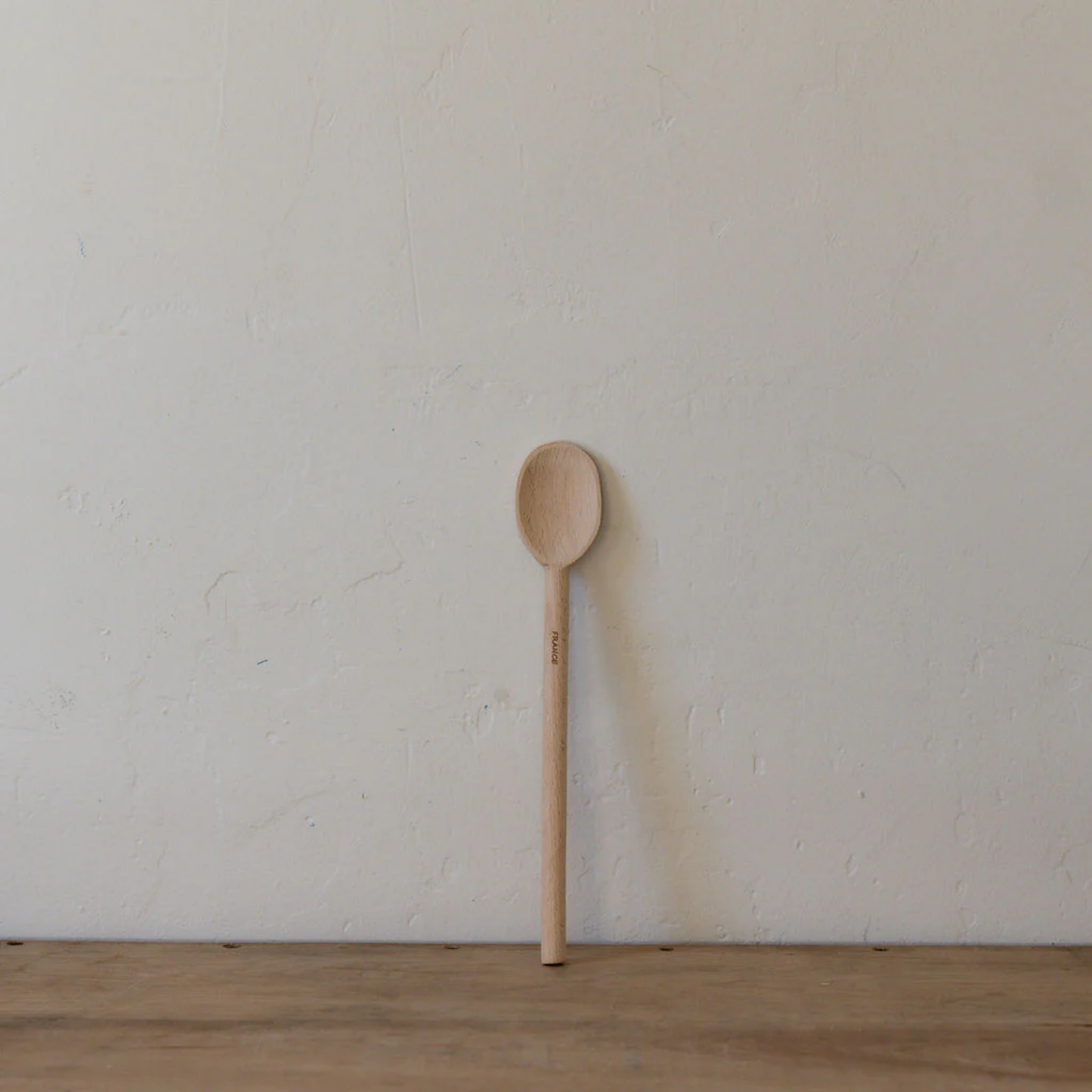 Front view of wooden spoon 30 cm on wooden table 