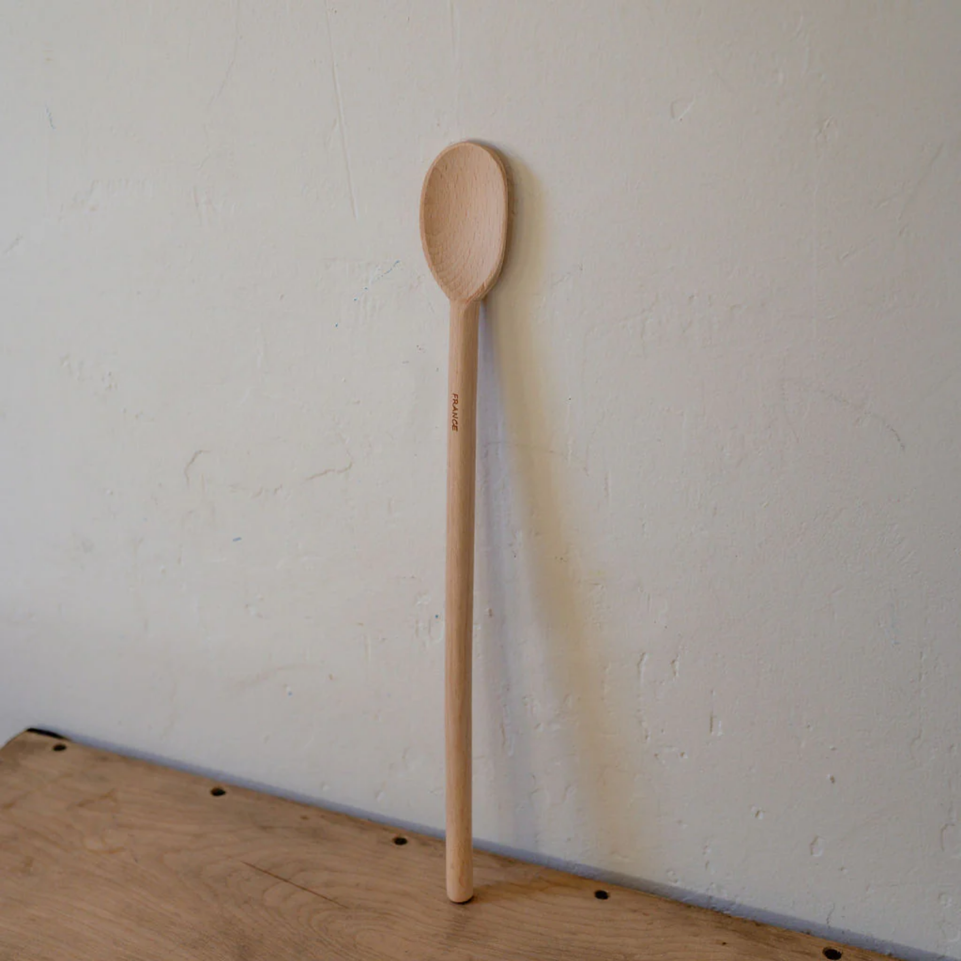 Front angled view of wooden spoon 35 cm on wooden table 
