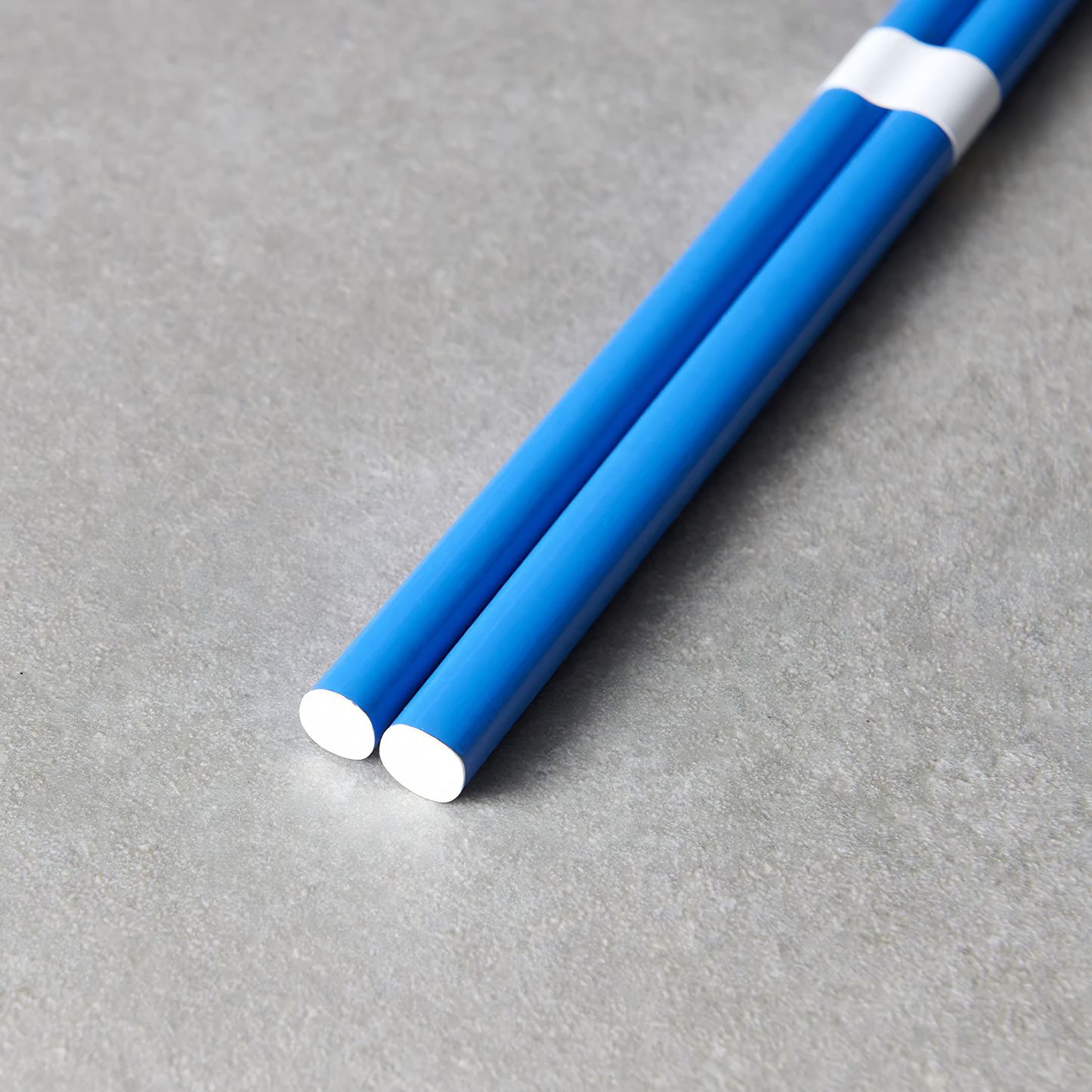Close up on the bottom part of the Fathom Chopsticks Pair Lacquered Royal blue finish with subtle white accent for smooth and glossy surface.
