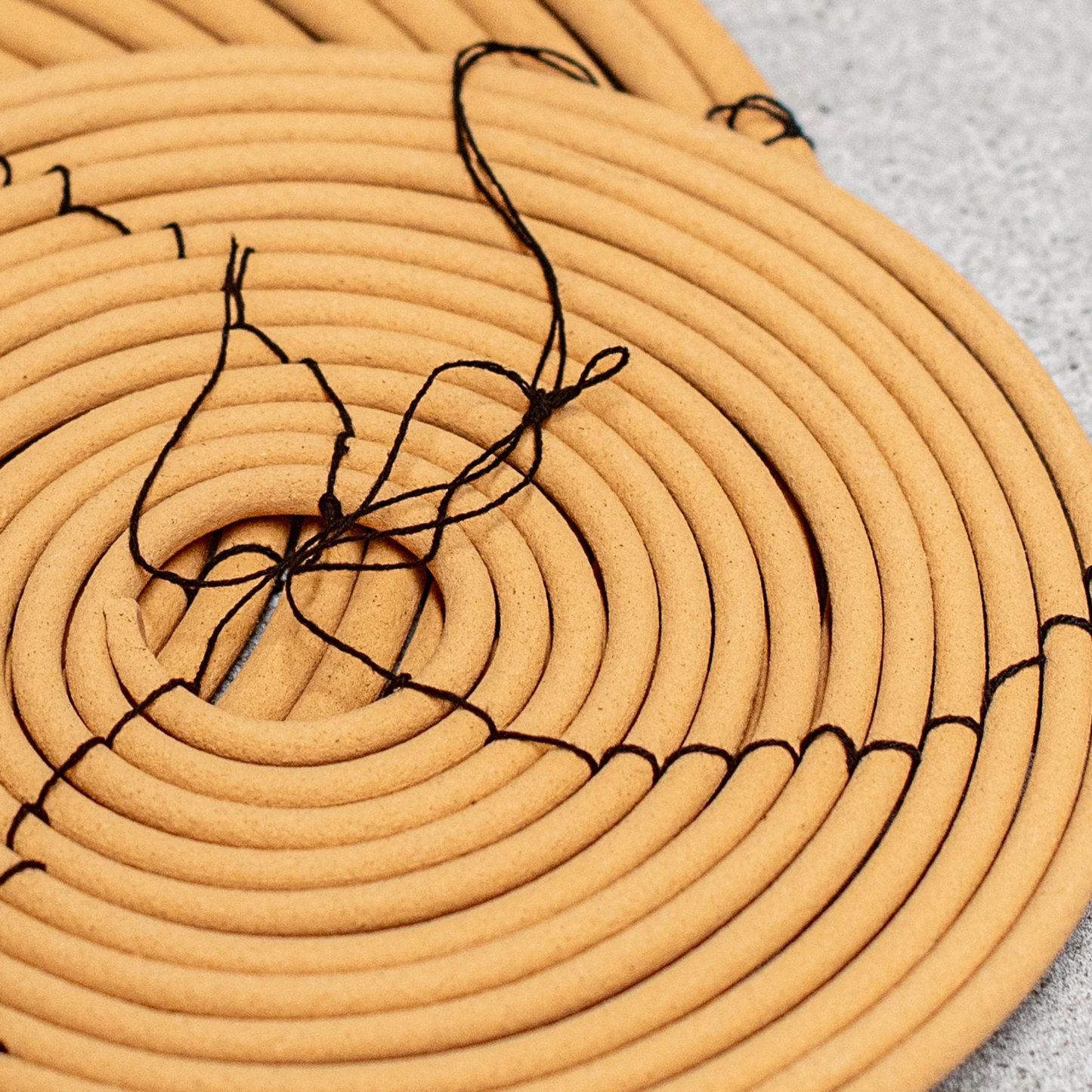 Heaven in Earth Citronella Coil Hanging Large with small citronella coil out of packaging close up