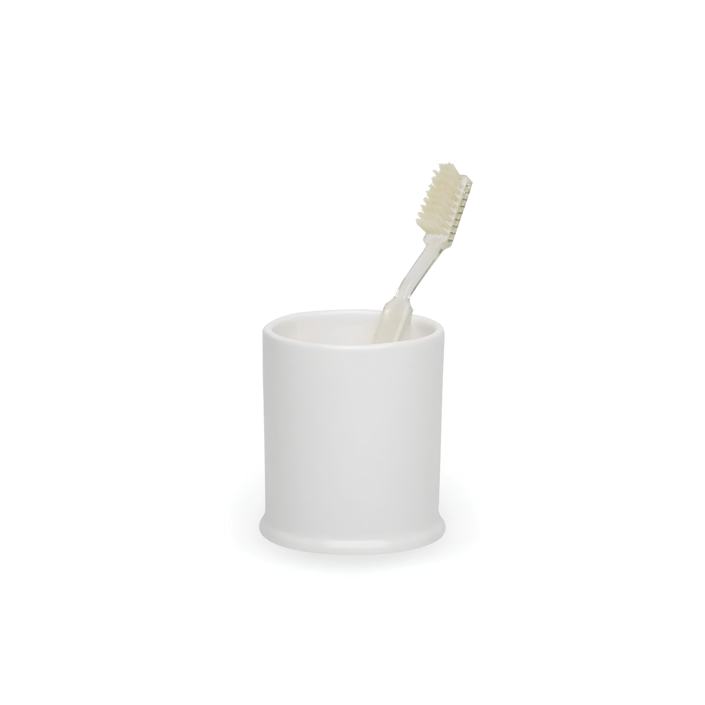 Fathom classic bathroom tumbler in crisp white shown with a toothbrush, a minimalist ceramic cup for toothbrush storage or rinsing, modern bathroom accessory.