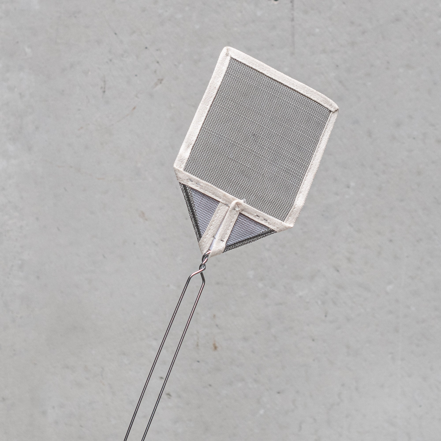 Solo back view of Fathom French mesh fly swatter with natural handle, 54cm lightweight insect control tool for indoor and outdoor use in kitchens, patios, and dining areas.