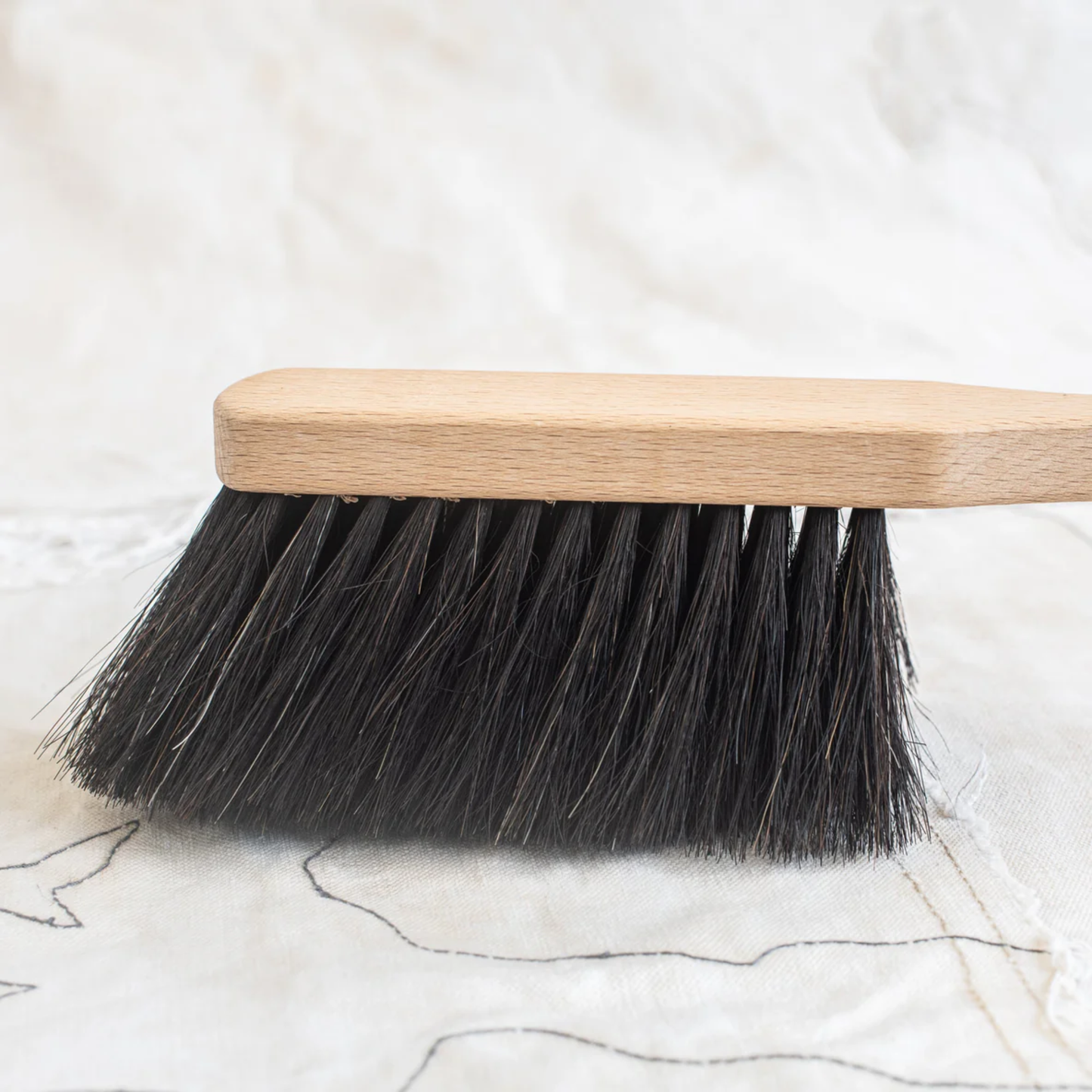 Side view of Fathom Horse Hair Hand Dust Brush - German-made 29x4x7cm beech wood handle with natural waxed finish, pure horsehair bristles in black or light beard, durable eco-friendly cleaning brush, ideal for pairing with elegant dustpans.