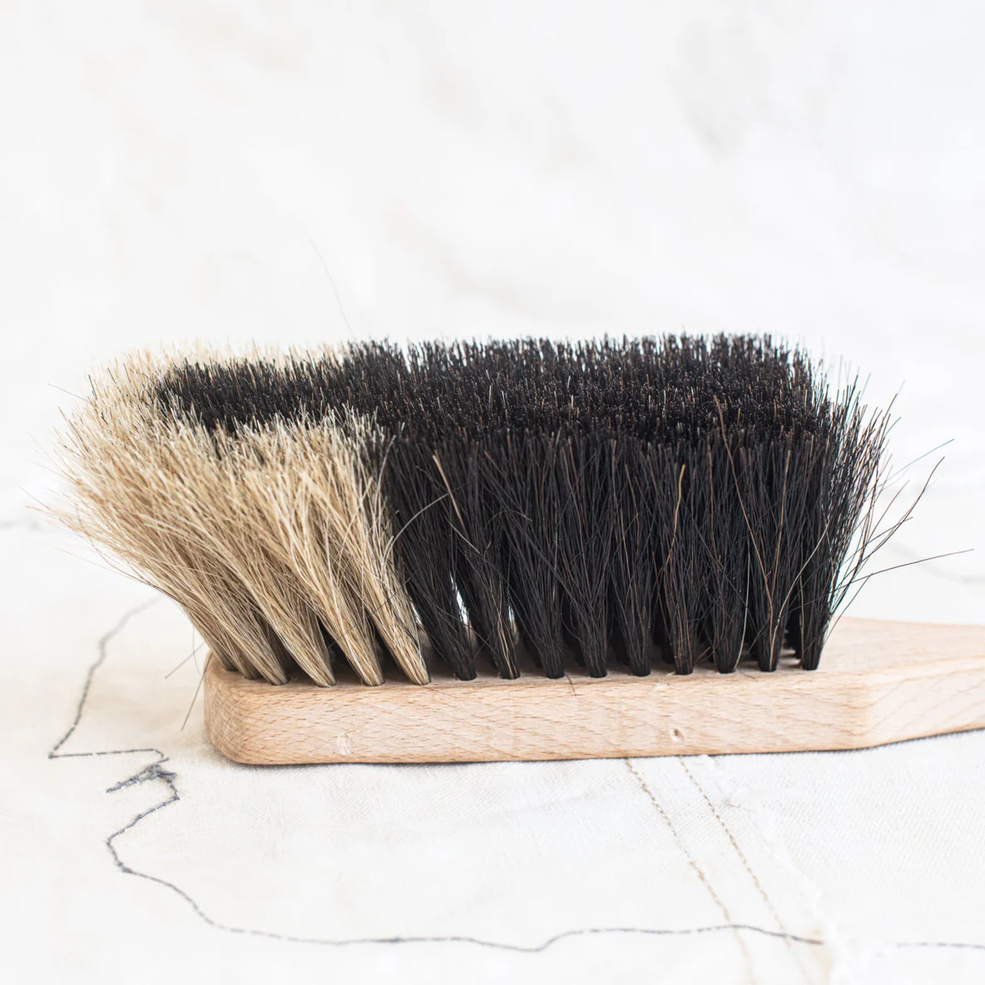 Side view of Fathom Hand Brush Horse Hair Two Tone, German-made beech wood handle, black or light horsehair, hand-held cleaning brush.