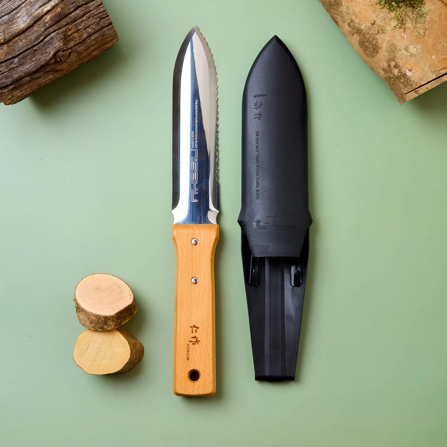 Fathom Hori Hori Japanese Garden Knife with Sheath features a dual edged that is one serrated and one straight with scalloped stainless steel, hardwood handle and hard sheath.