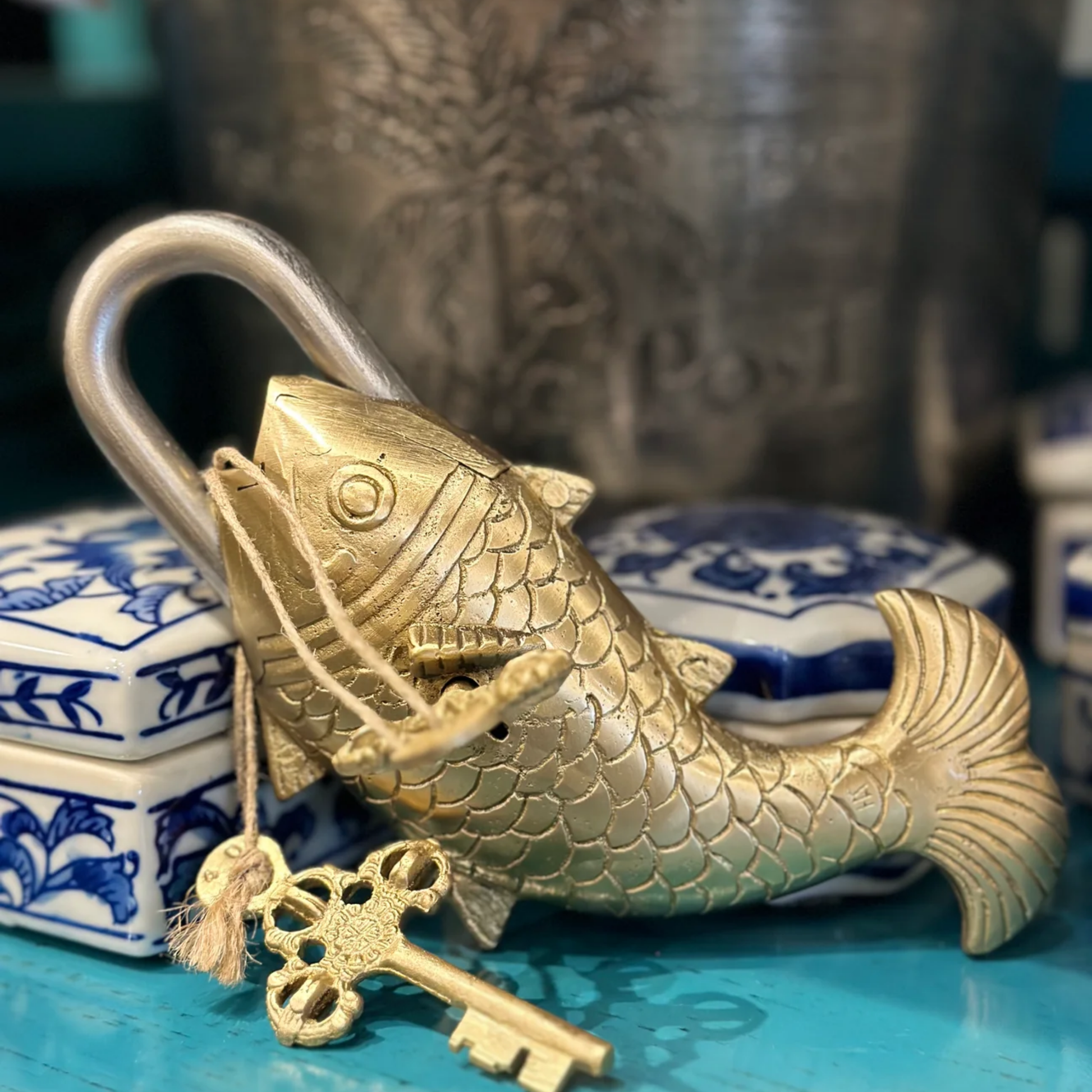 Indian brass fish padlock with keys on its side 