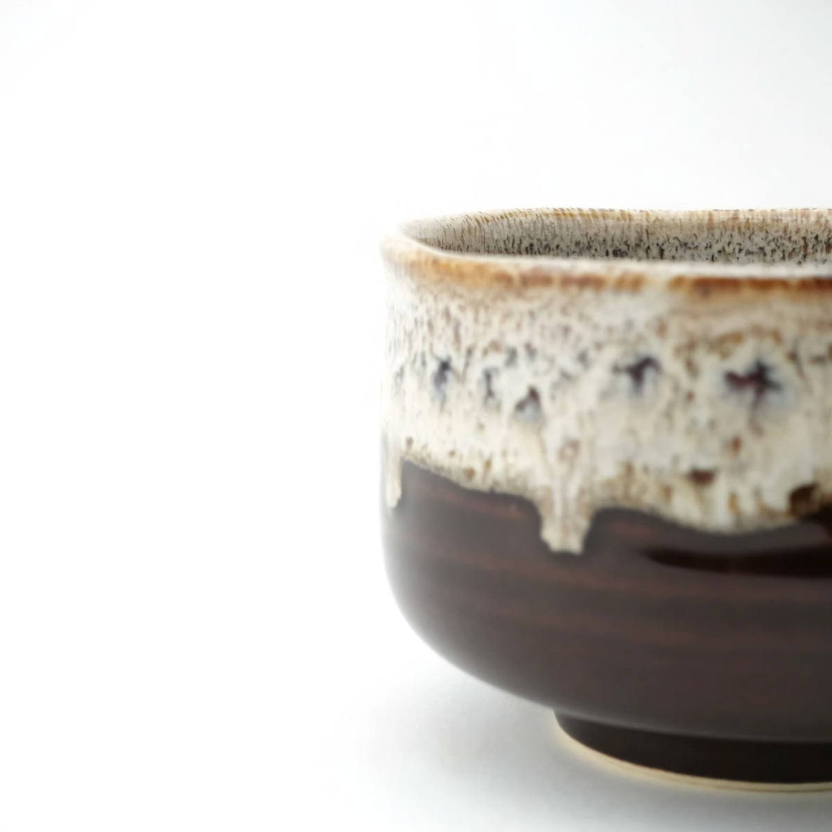 Close up side view of the Fathom Japanese Hasami Ware Matcha Bowl in amber, ceramic with textured finish, compact lightweight design for casual matcha.