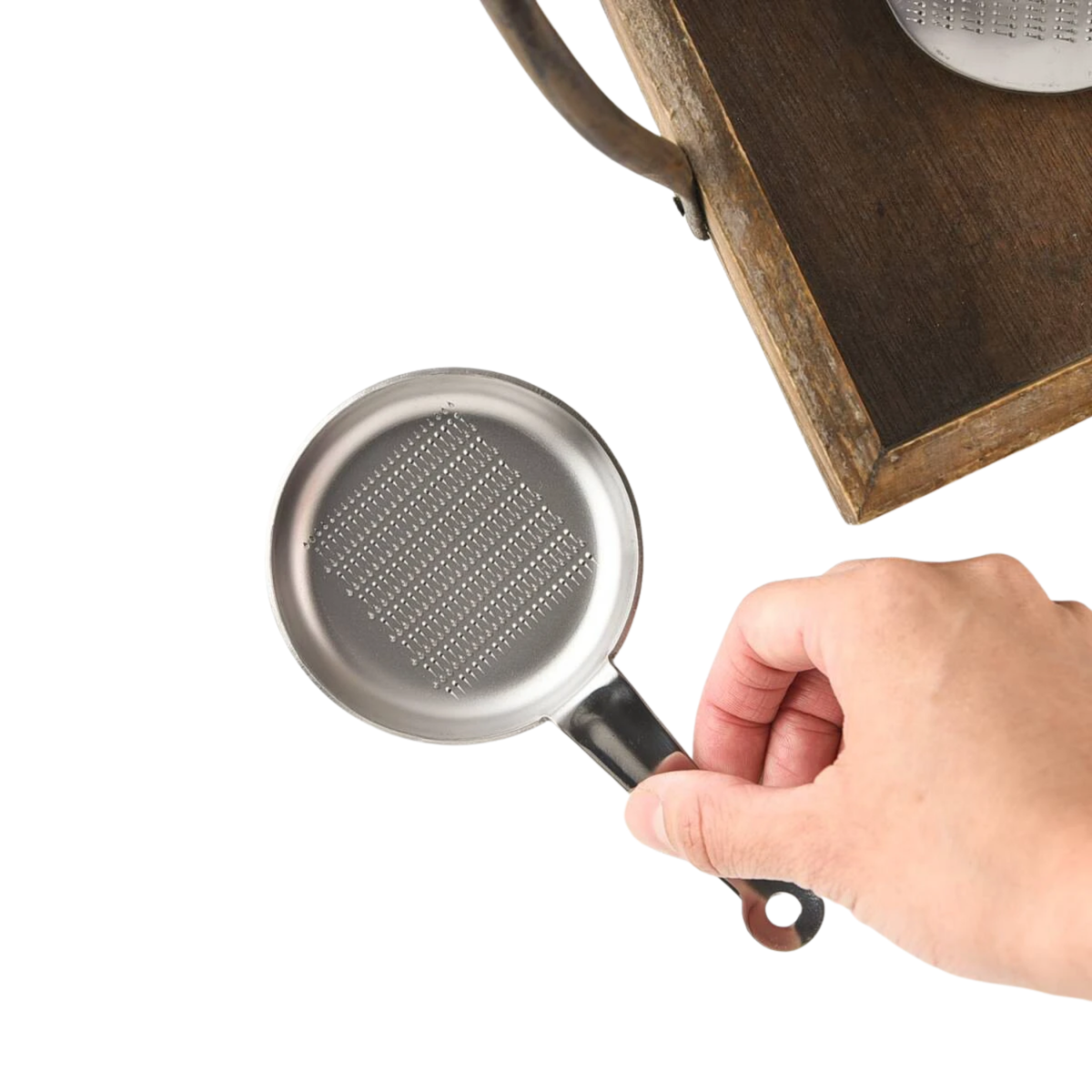 Fathom Japanese Mini Grater White Ceramic, compact design for grating small amounts of salt, ginger, and wasabi, etc, shown o a surface held by a hand.