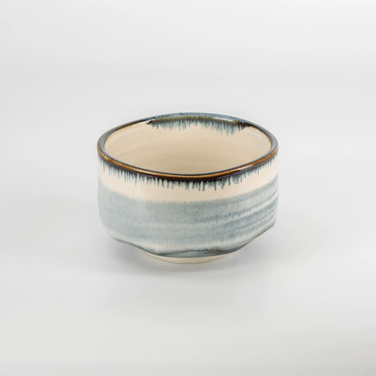Semi top view of the bowl from Fathom Japanese Mino Ware Matcha Bowl and Whisk Set in blue, ceramic with bamboo whisk, featuring 100-prong chasen.
