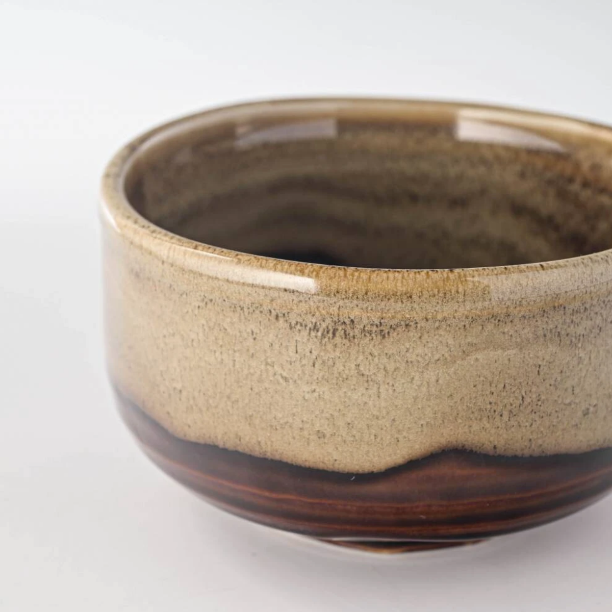 Close up semi side view of Fathom Japanese Mino Ware Matcha Bowl Miyajima Amber Ceramic, hand-crafted with a rich, lustrous glaze.