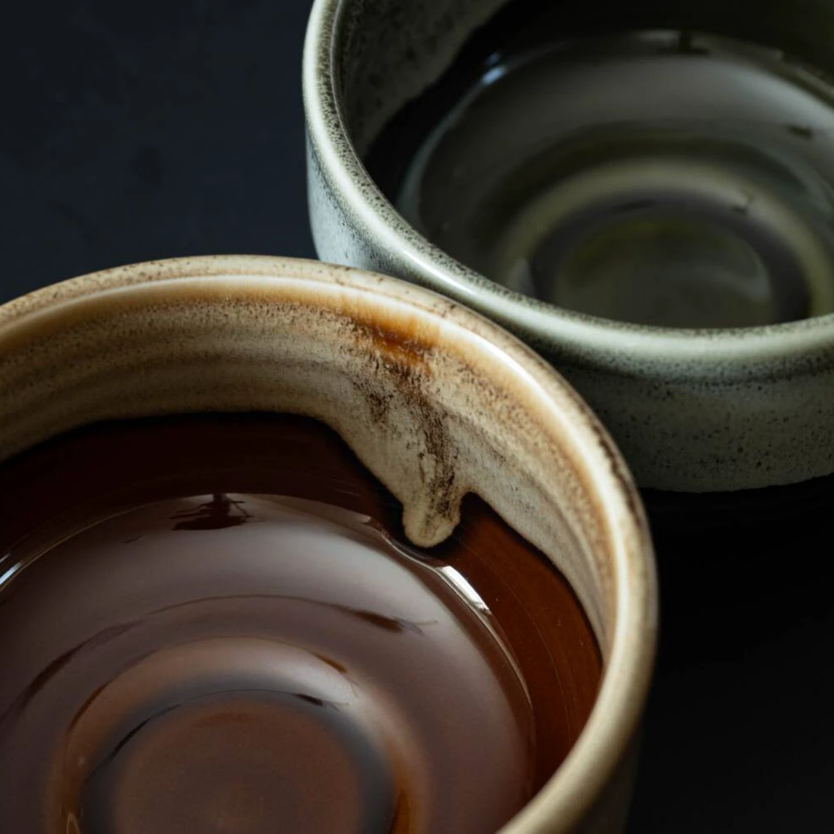 Fathom Japanese Mino Ware Matcha Bowl Miyajima Amber Ceramic, hand-crafted with a rich, lustrous glaze, shown with another variant of the bowl.