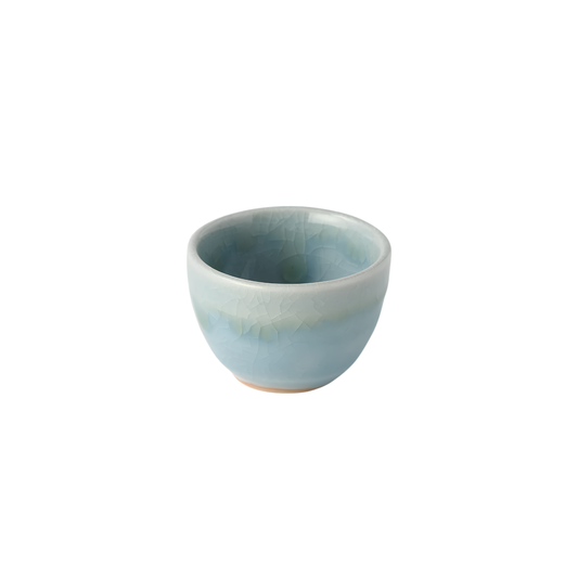 Semi top view of Fathom Japanese Sake Cup in blue, ceramic with a crazed glaze and 30ml serving capacity.