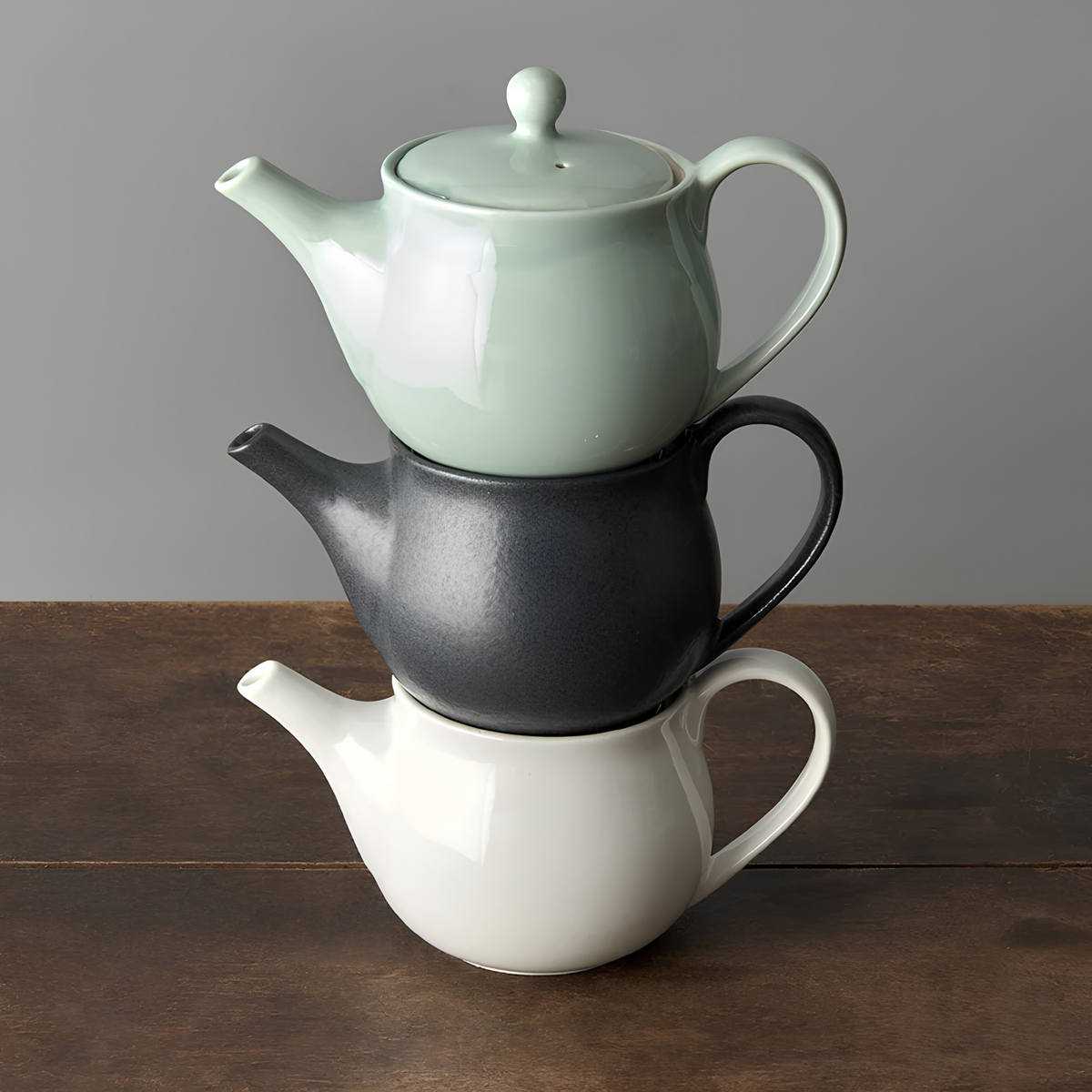 Stacked pots with the Fathom Japanese Teapot in matt black, ceramic with satin glaze, rounded form and graceful spout for smooth pouring.