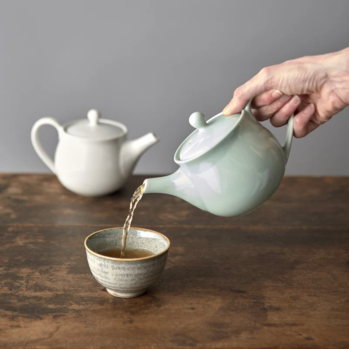 Pouring coffee from Fathom Japanese Teapot in light green, ceramic with smooth Tomei glaze, 400ml capacity and balanced form for smooth pouring.