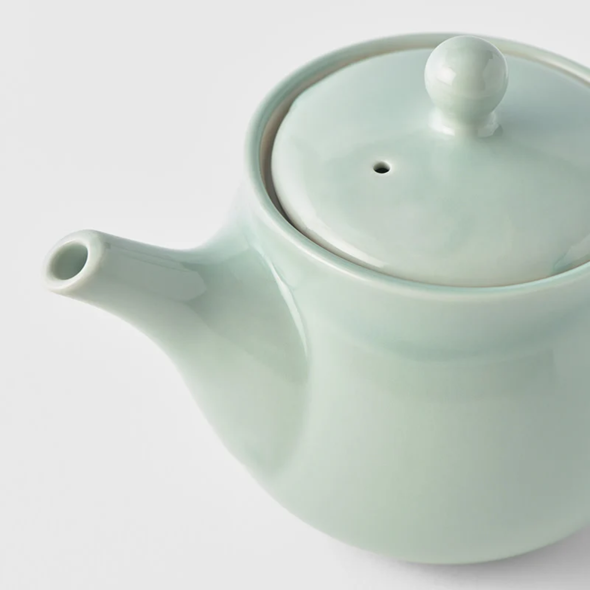 Close up on the Fathom Japanese Teapot in light green, ceramic with smooth Tomei glaze, 400ml capacity and balanced form for smooth pouring.
