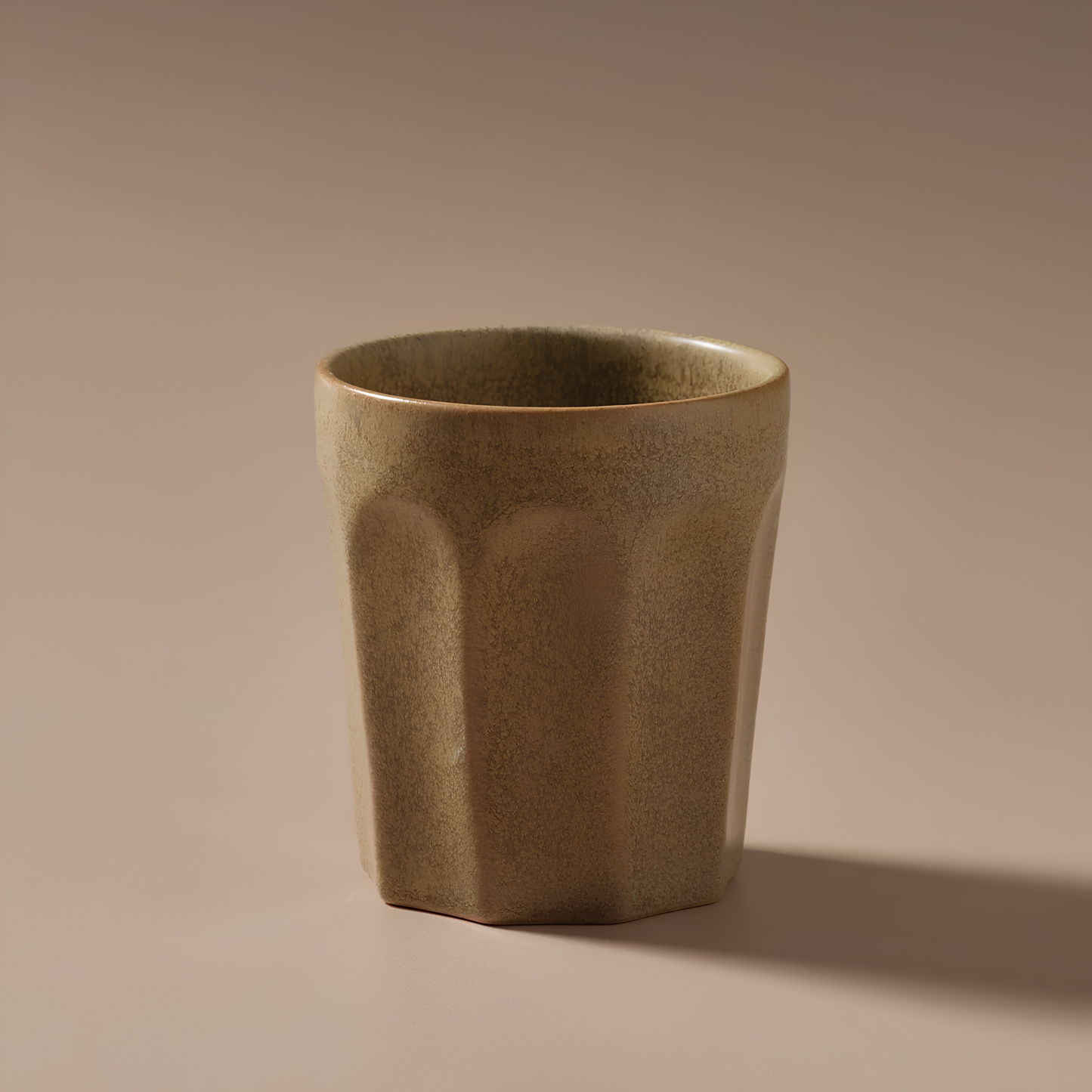 Front view with a background of Fathom Latte Cup Biscuit stoneware that is handcrafted with reactive glazes of earthly hues finish.