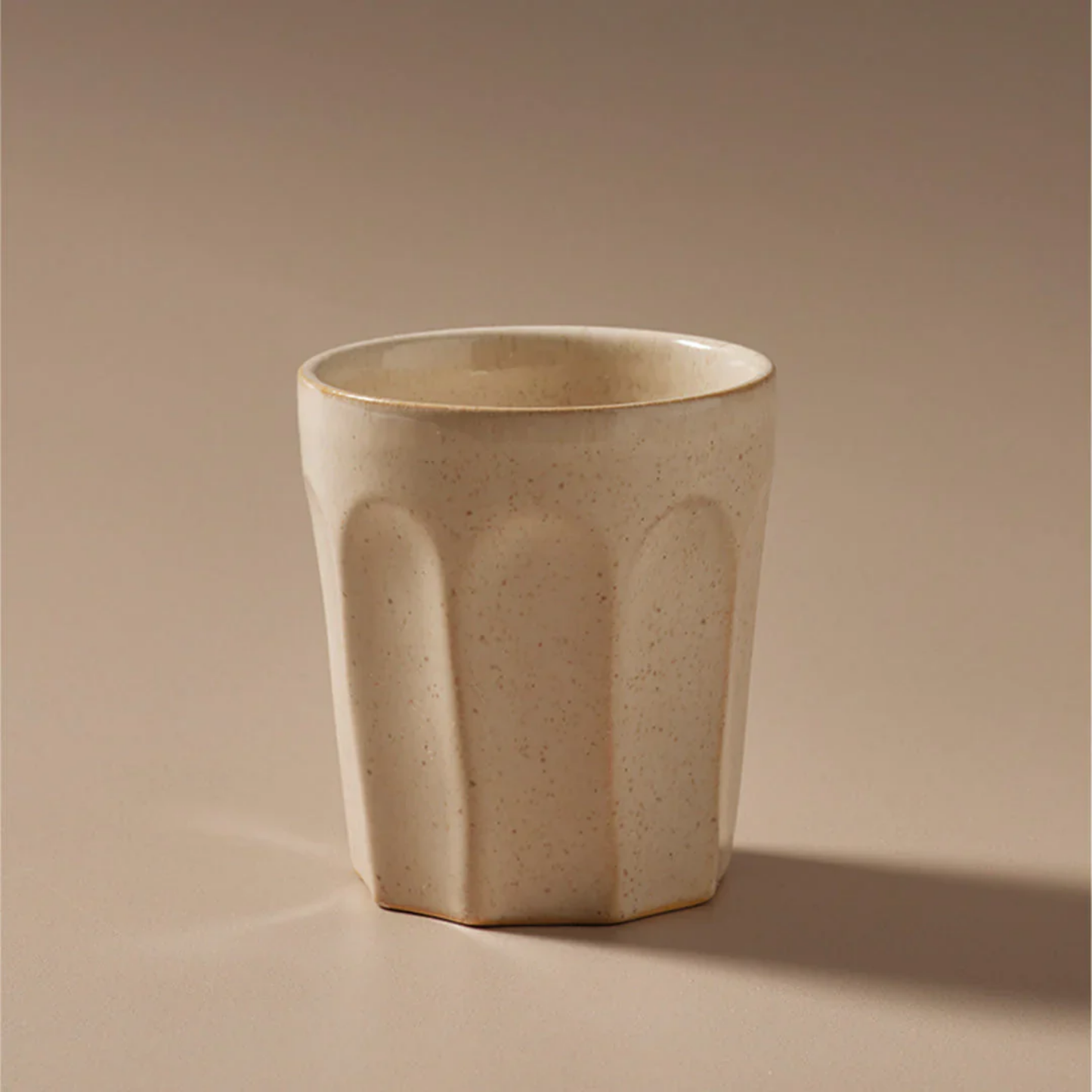 Off white latte mug front view close up with warm beige back drop