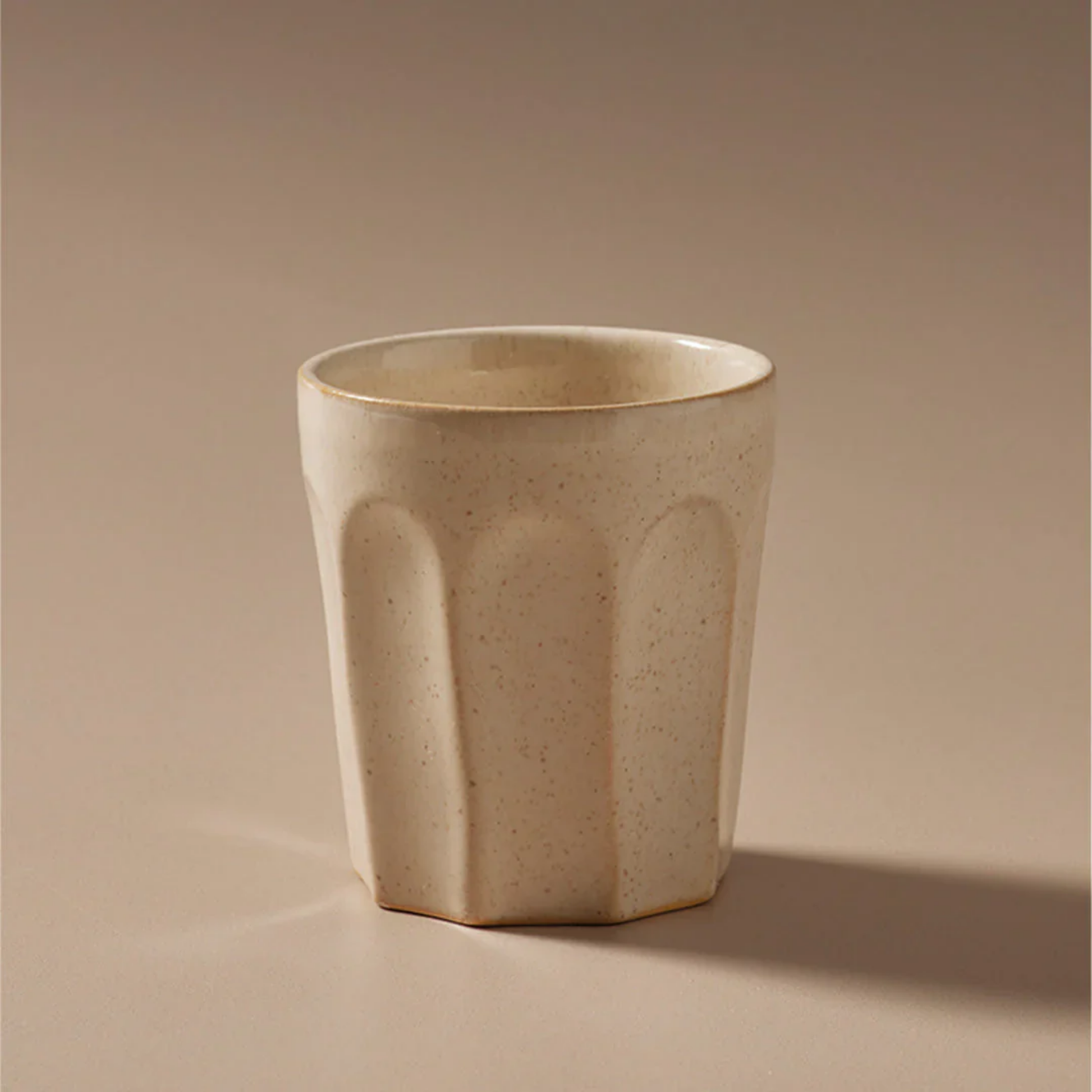Off white latte mug front view close up with warm beige back drop