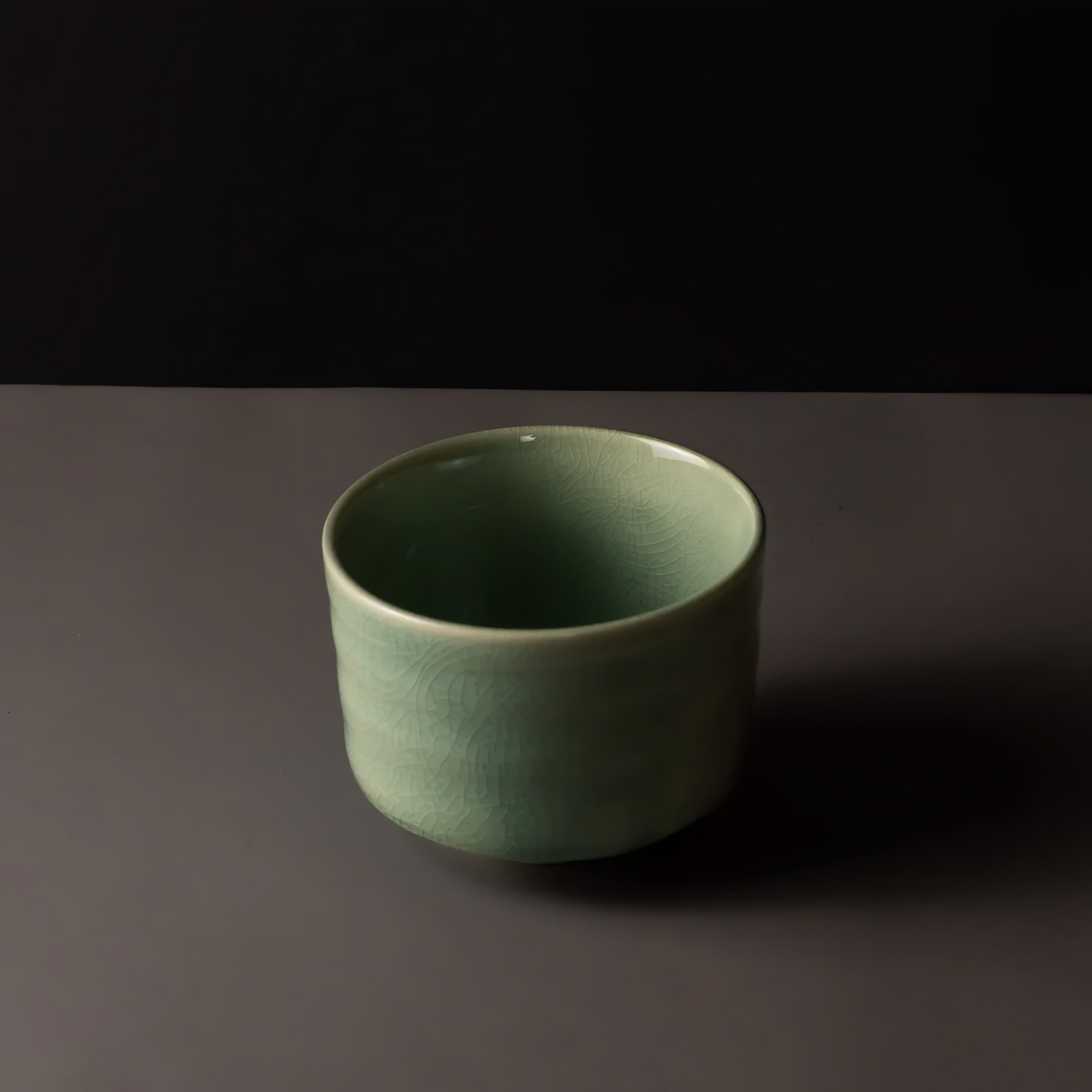 Semi top view of the Fathom Matcha Tea Bowl 10cm Jade wit glaze that is smooth, glossy soft green with gentle natural colour.