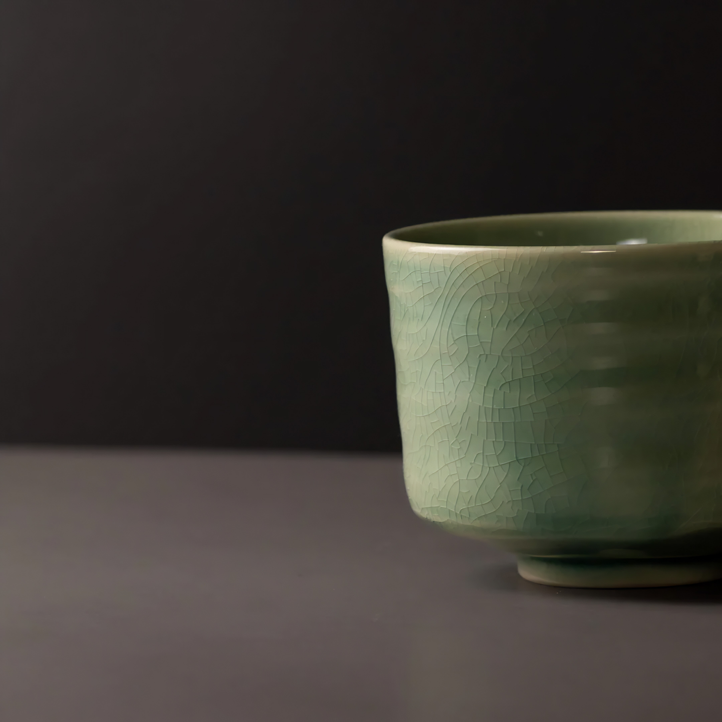 Close up view of the Fathom Matcha Tea Bowl 10cm Jade wit glaze that is smooth, glossy soft green with gentle natural colour.